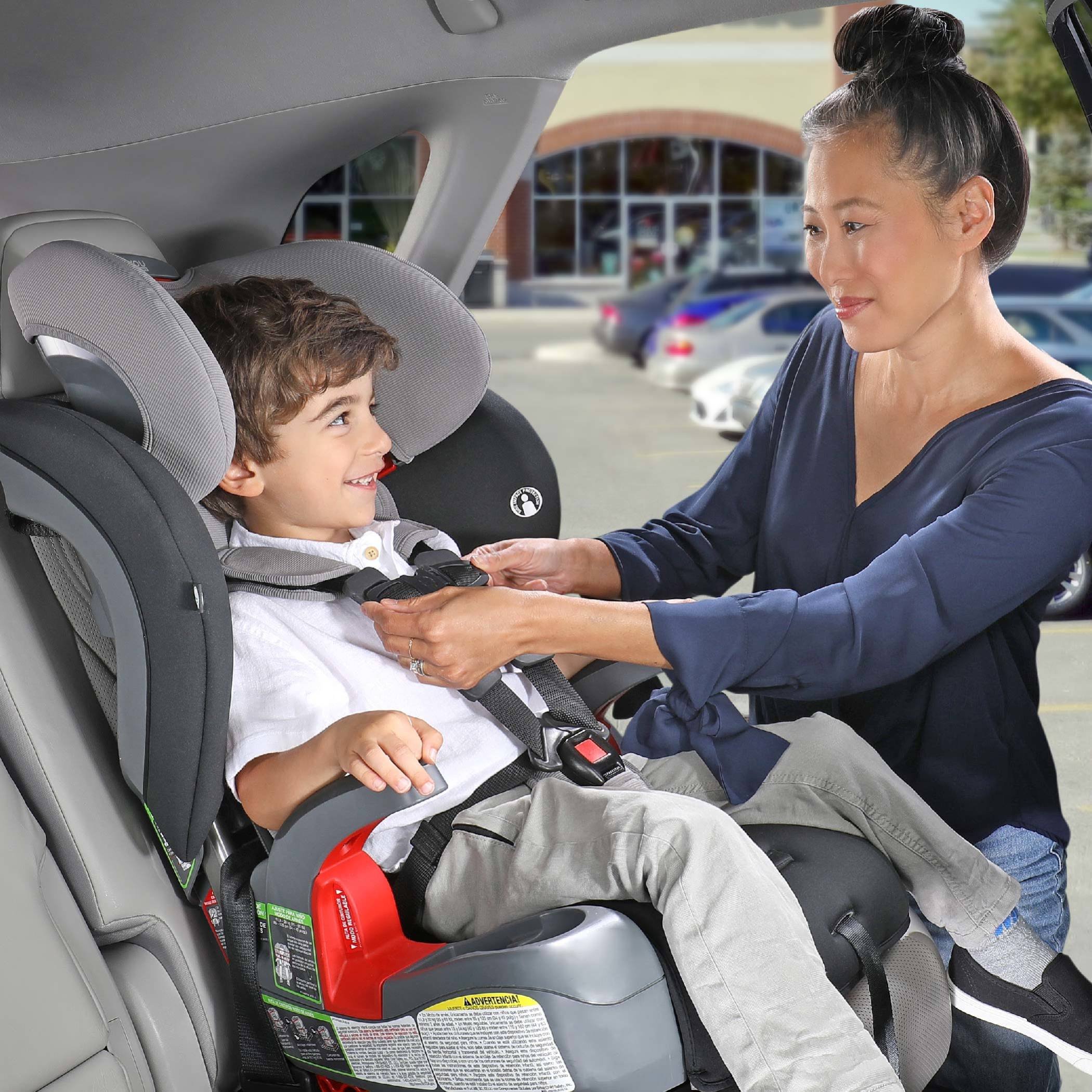 Mother Adjusting the Harness on childs car seat (Copy)