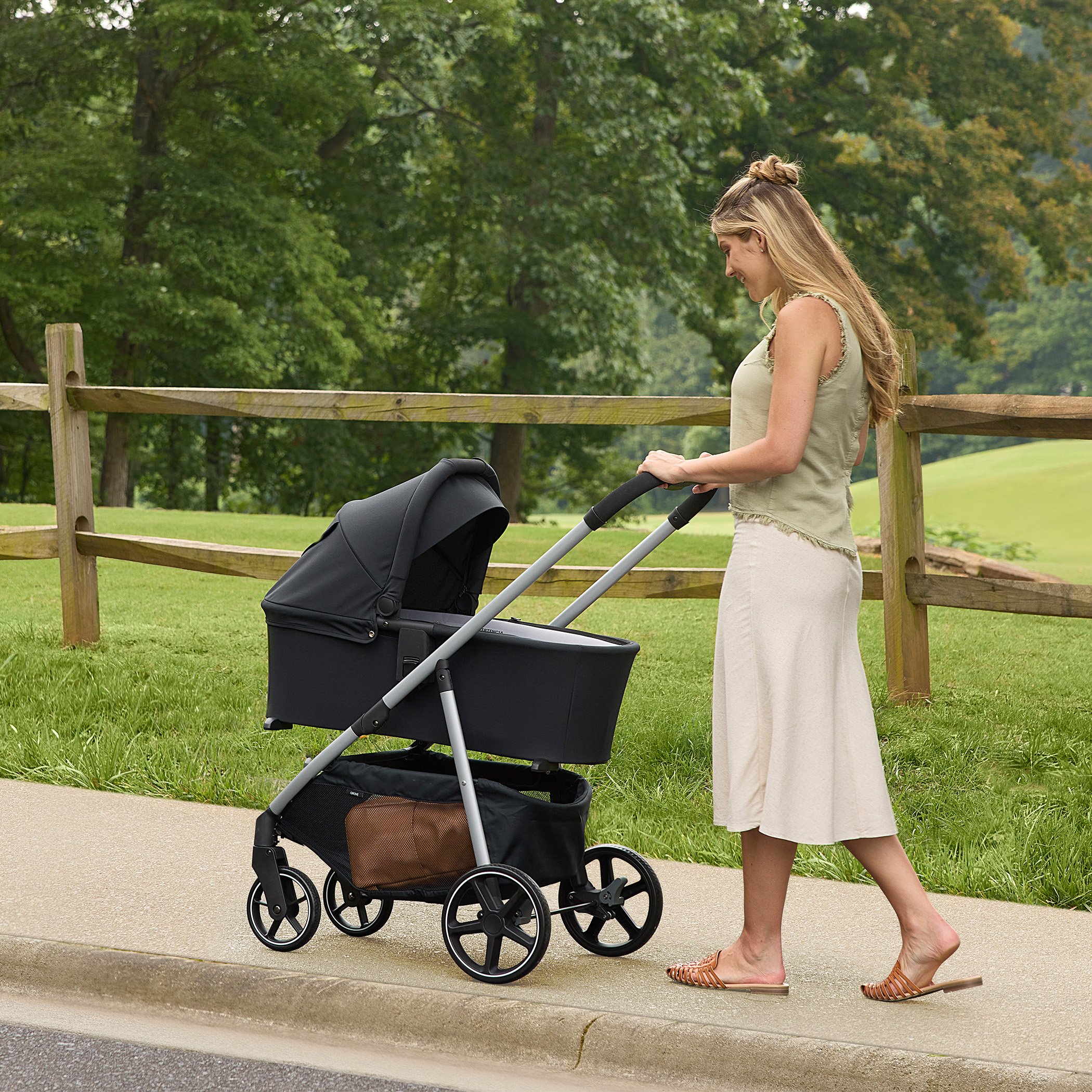 Mother Strolling along using the grover stroller and Zinnia Bassinet 
