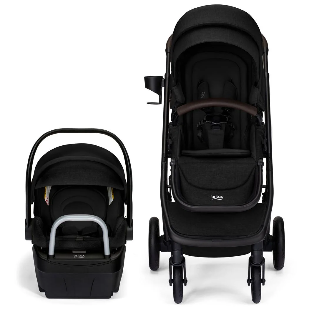 A black stroller and infant car seat on a car seat base. The stroller has a cup holder, a canopy, and a bumper bar. 