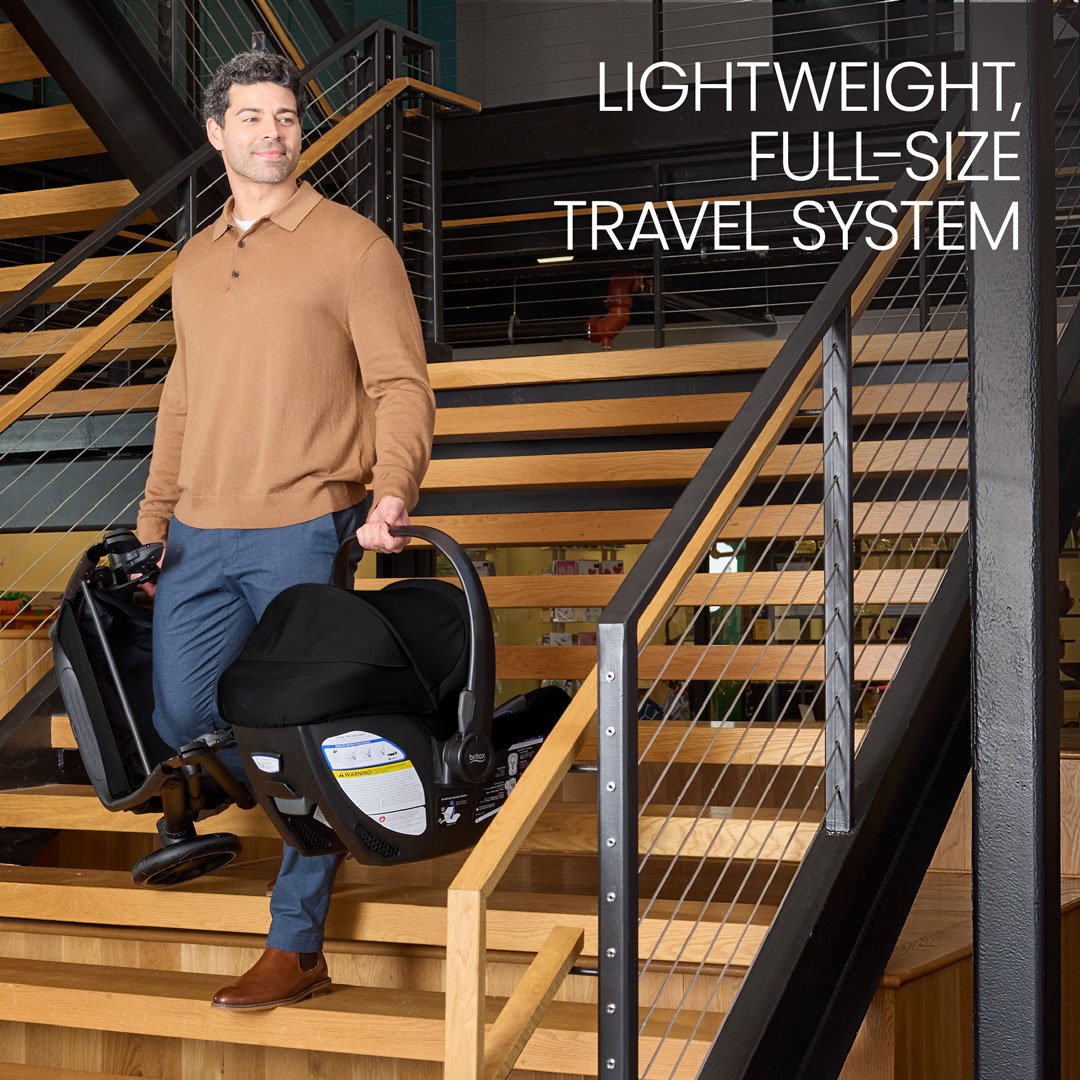 Lightweight, full-size travel system. A man carrying a folded baby stroller and an infant car seat down an indoor staircase. 
