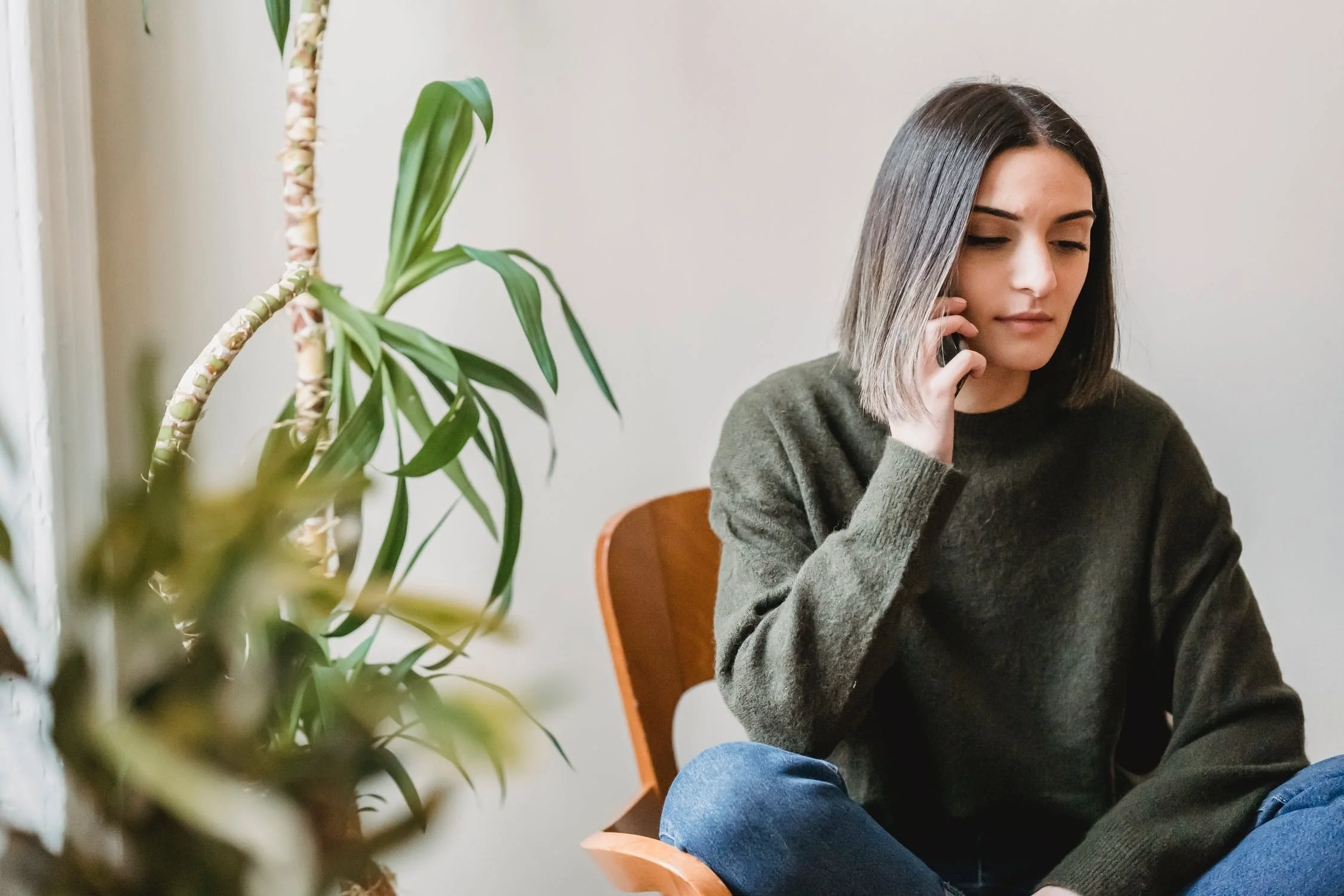 woman sitting in chair on phone.jpeg