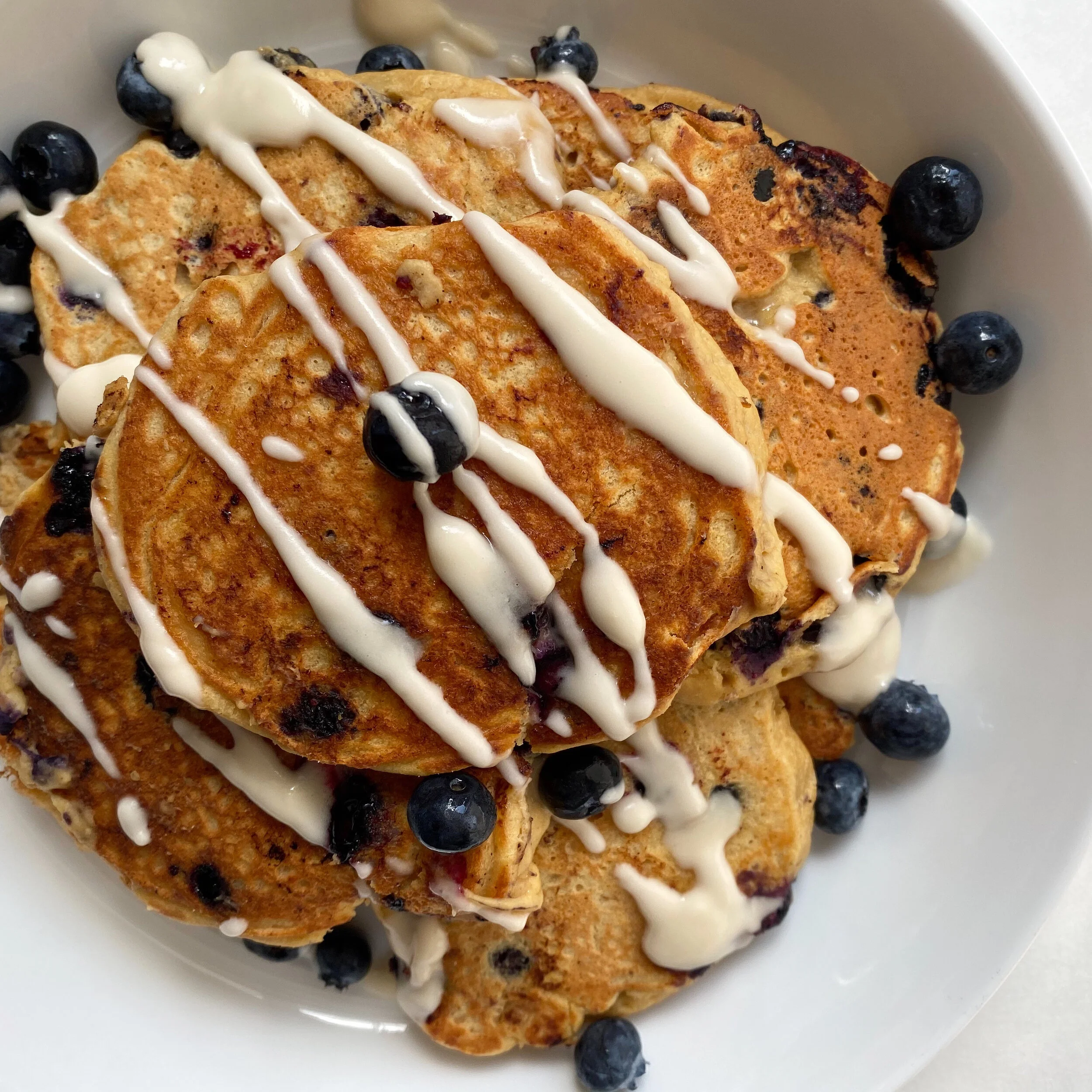 blueberry lemon ricotta pancakes with a lemon glaze