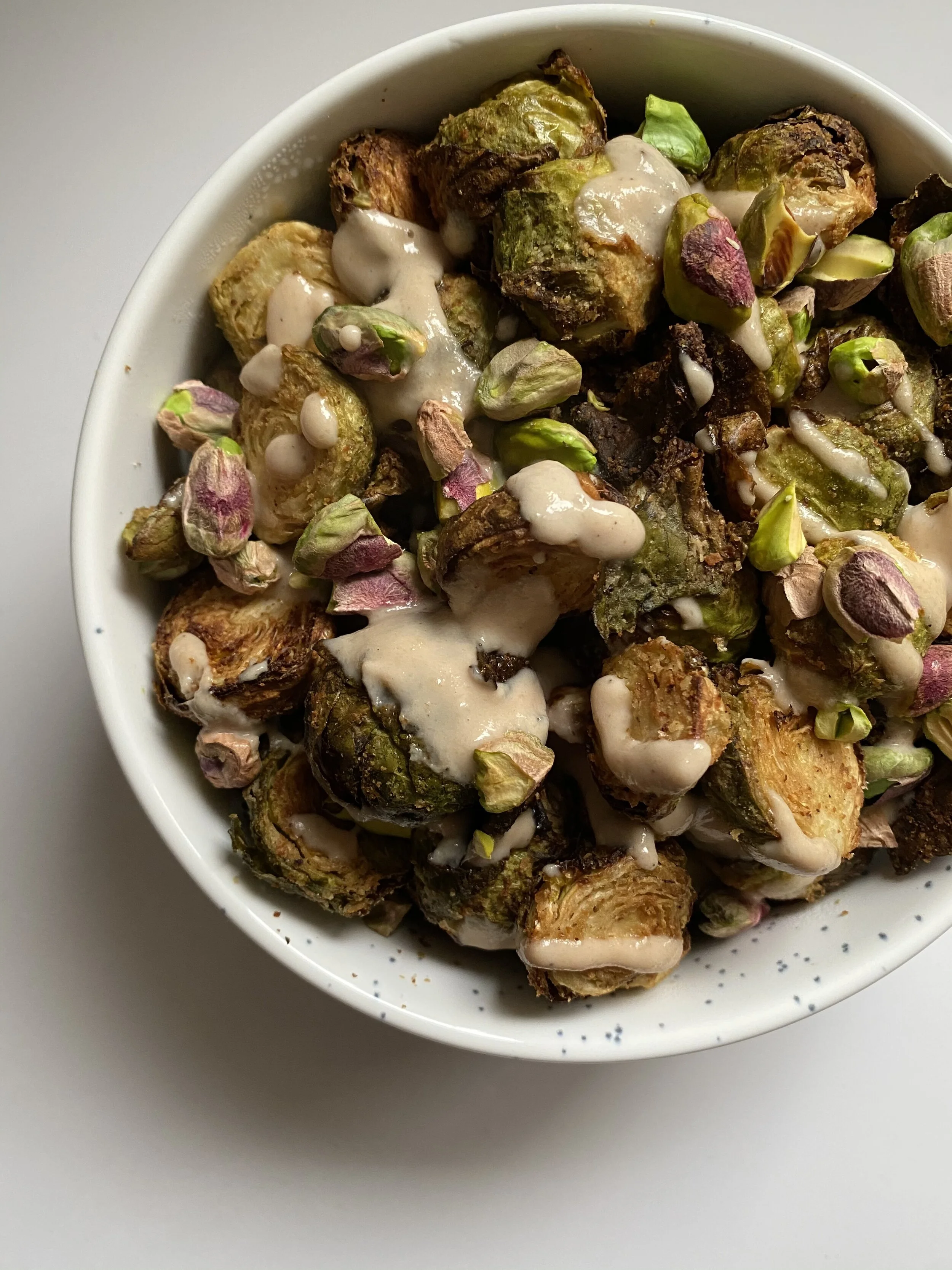 Crispy Brussel Sprouts with a Lemony Red Wine Vinegar Tahini Sauce with Roasted Pistachios