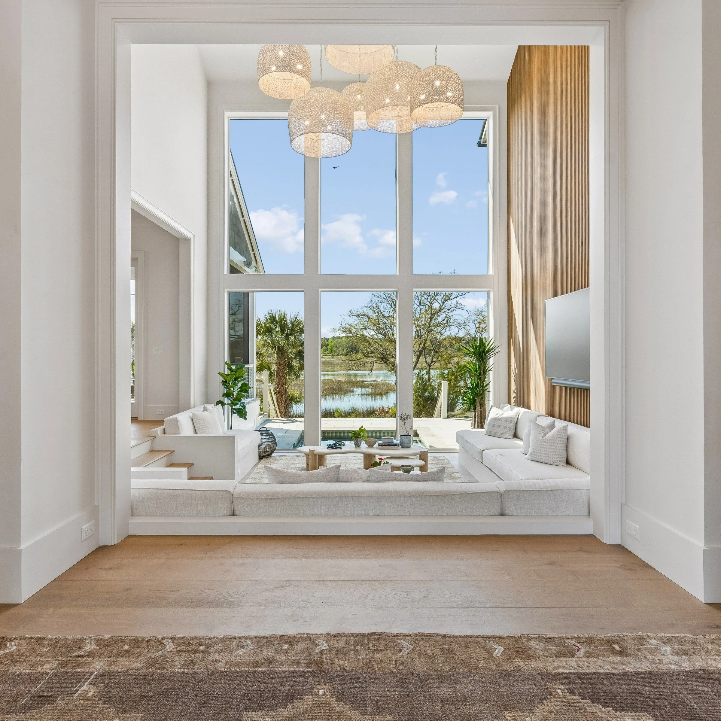 Opening the front door to a view straight through the sunken living room and out to the Awendaw marsh. A simple arrival moment designed to keep the landscape front and center.

#Awendaw #LowcountryLiving #CharlestonArchitecture #SunkenLivingRoom #Sun