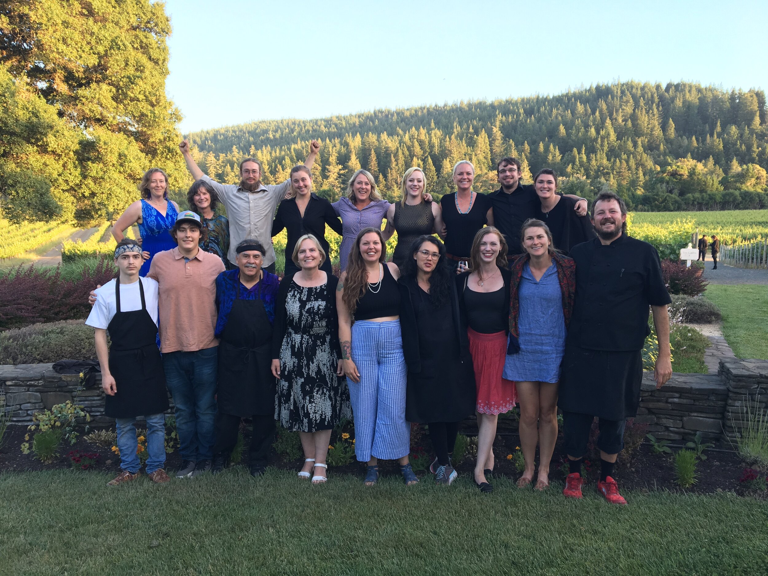 Group of participants at the Goldeneye Winemaker Dinner link hand in the air (Copy)