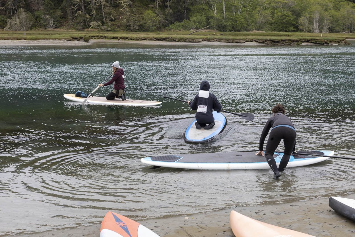 Three waterboarders leave the shore at Walk and Paddle for Cancer (Copy)