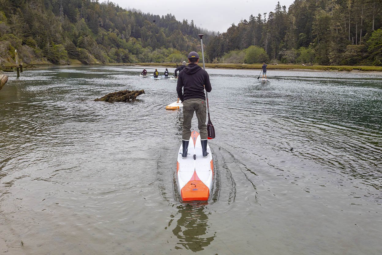 Waterboarder stands in the middle of the river at Walk and Paddle for Cancer (Copy)