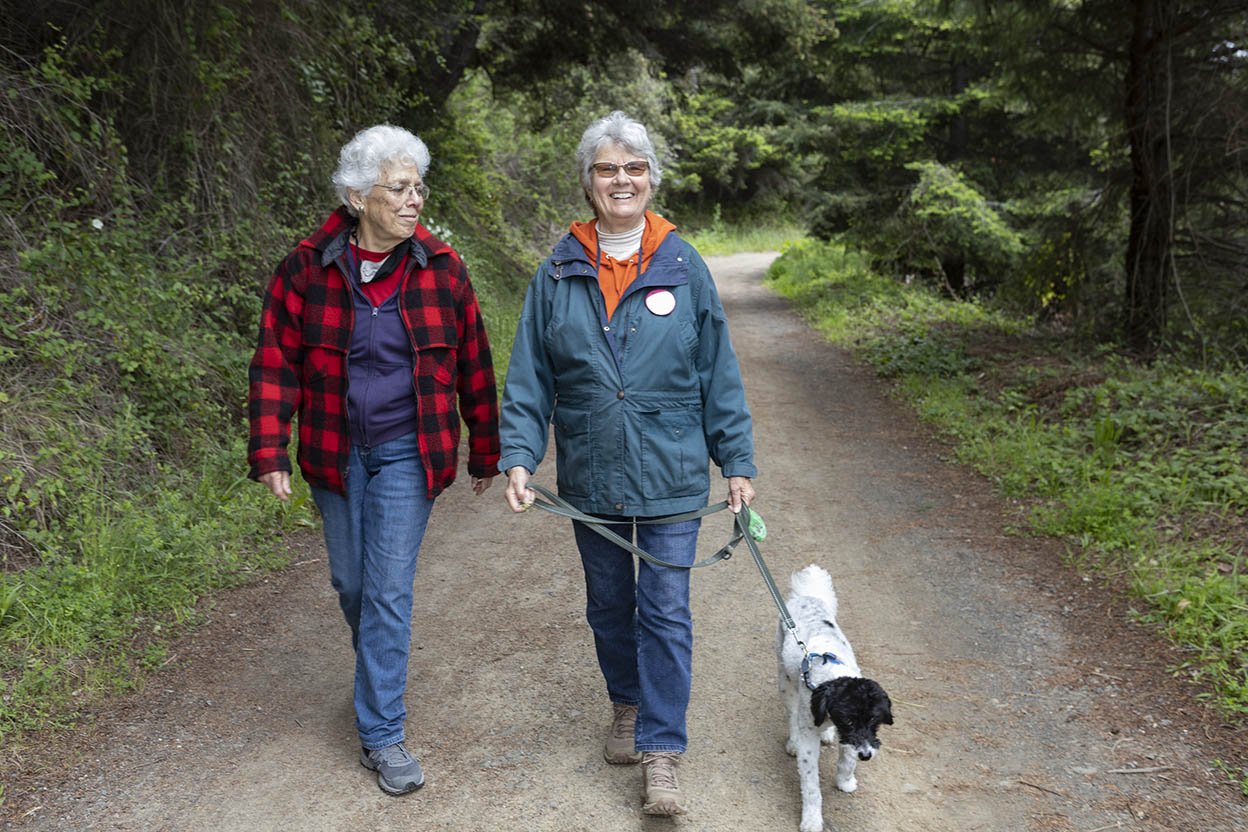 Two women walk with dog at Walk and Paddle for Cancer (Copy)