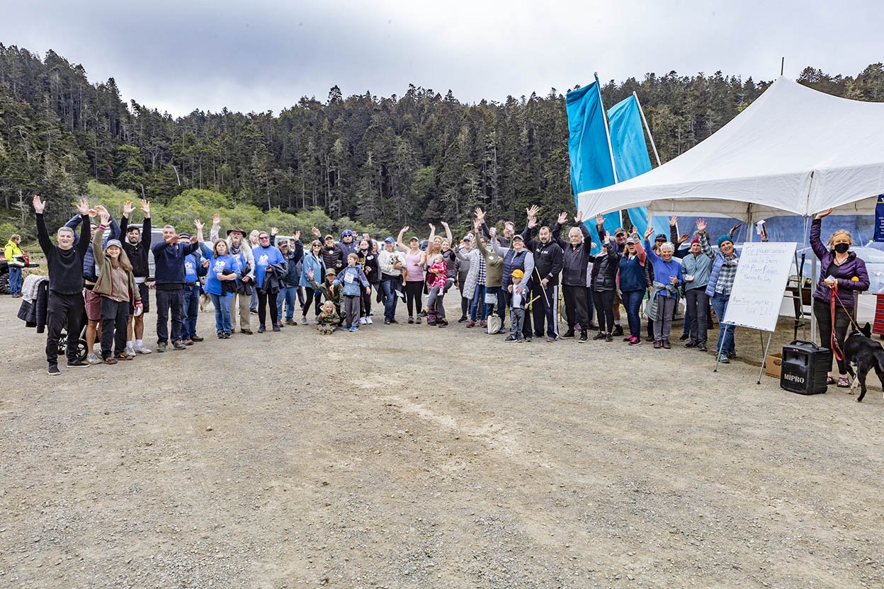 All the participants at Walk and Paddle 2022 line up in an arc  and wave (Copy)