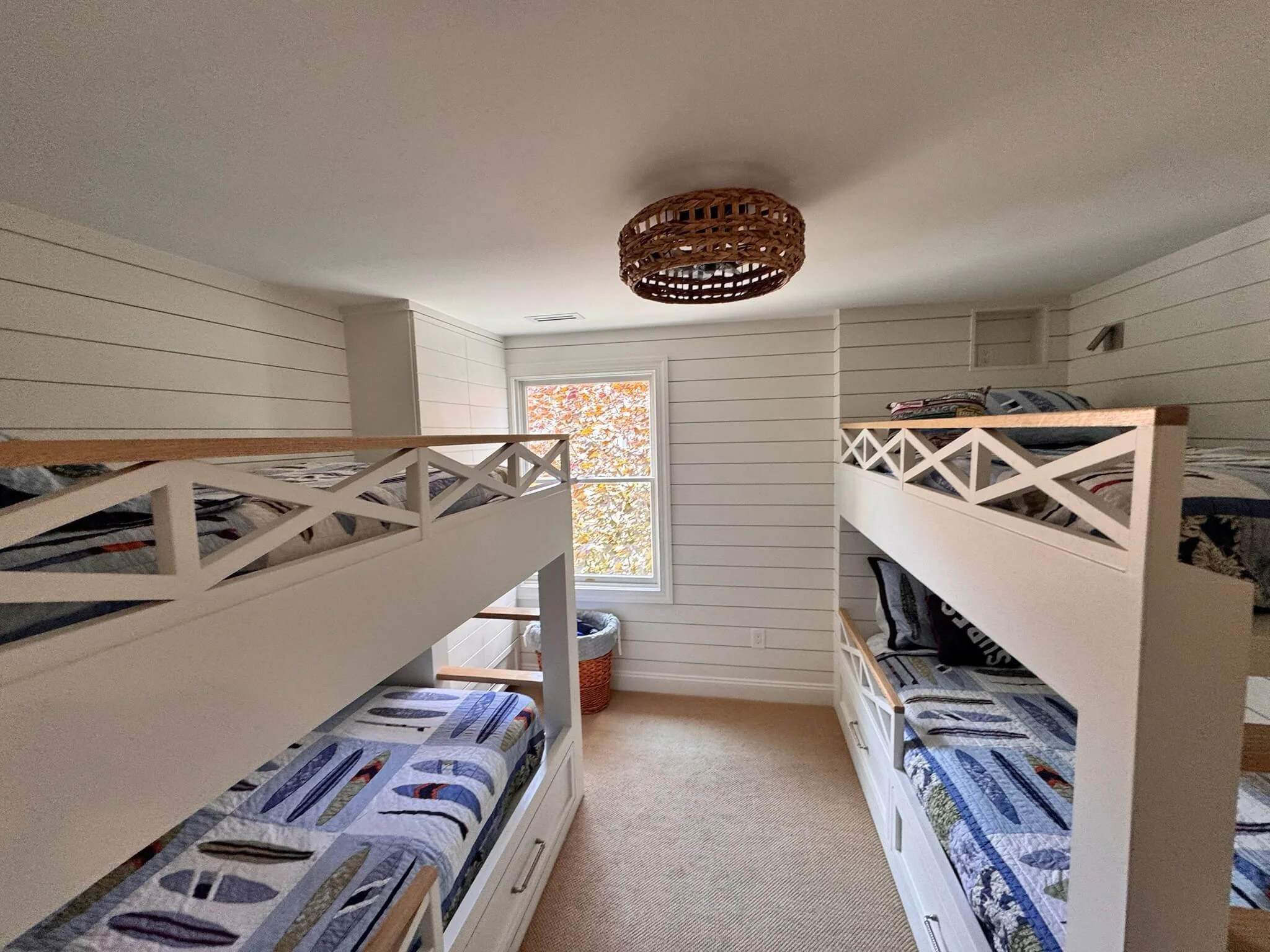 Custom built-in bunk bedroom with coastal trim design and integrated storage — Ocean City renovation by 2B Contracting.