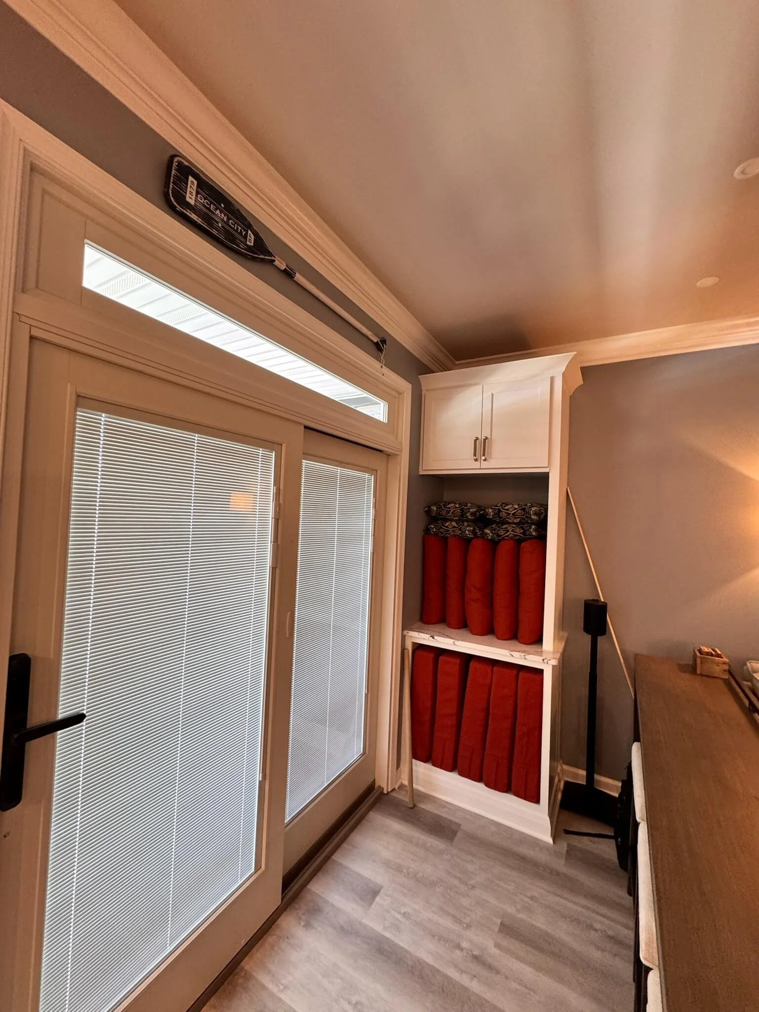 Custom built-in entry storage with beach-gear shelves and cabinetry in an Ocean City home, remodeled by 2B Contracting.