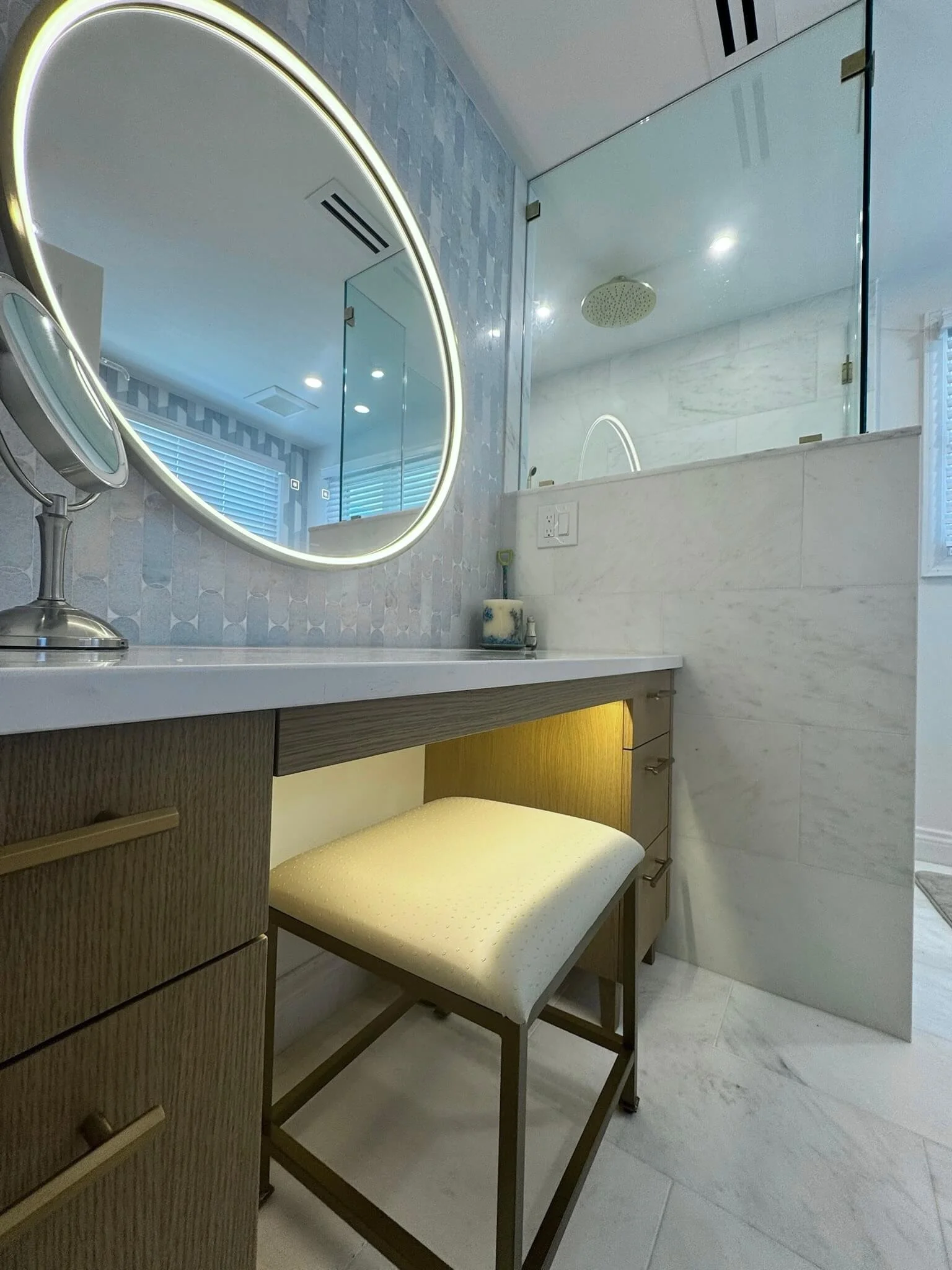 Hand-carved natural wood bathroom vanity with a polished marble countertop and brushed brass faucet, installed by 2B Contracting in Ocean City, NJ.