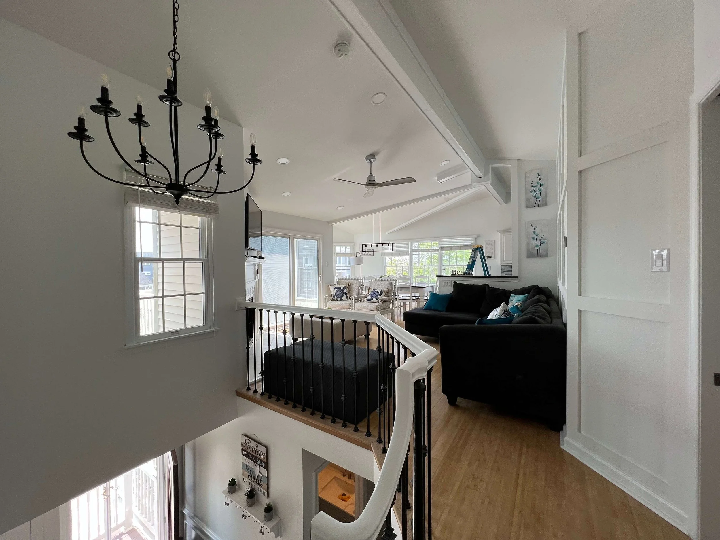 Coastal living room renovation with vaulted ceiling, custom millwork, and modern fireplace by 2B Contracting in Ocean City, NJ.