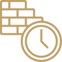 A person standing on a skateboard in a park at sunset with trees and buildings in the background.