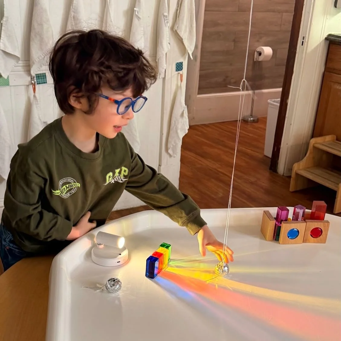 Light Is a Trickster! 
(A Green Dragonflies Perspective)
Light is not just light.
It&rsquo;s a trickster.
It plays different tricks depending on who it&rsquo;s with.
When light goes through the colorful blocks, it changes its clothes.
If it goes thro