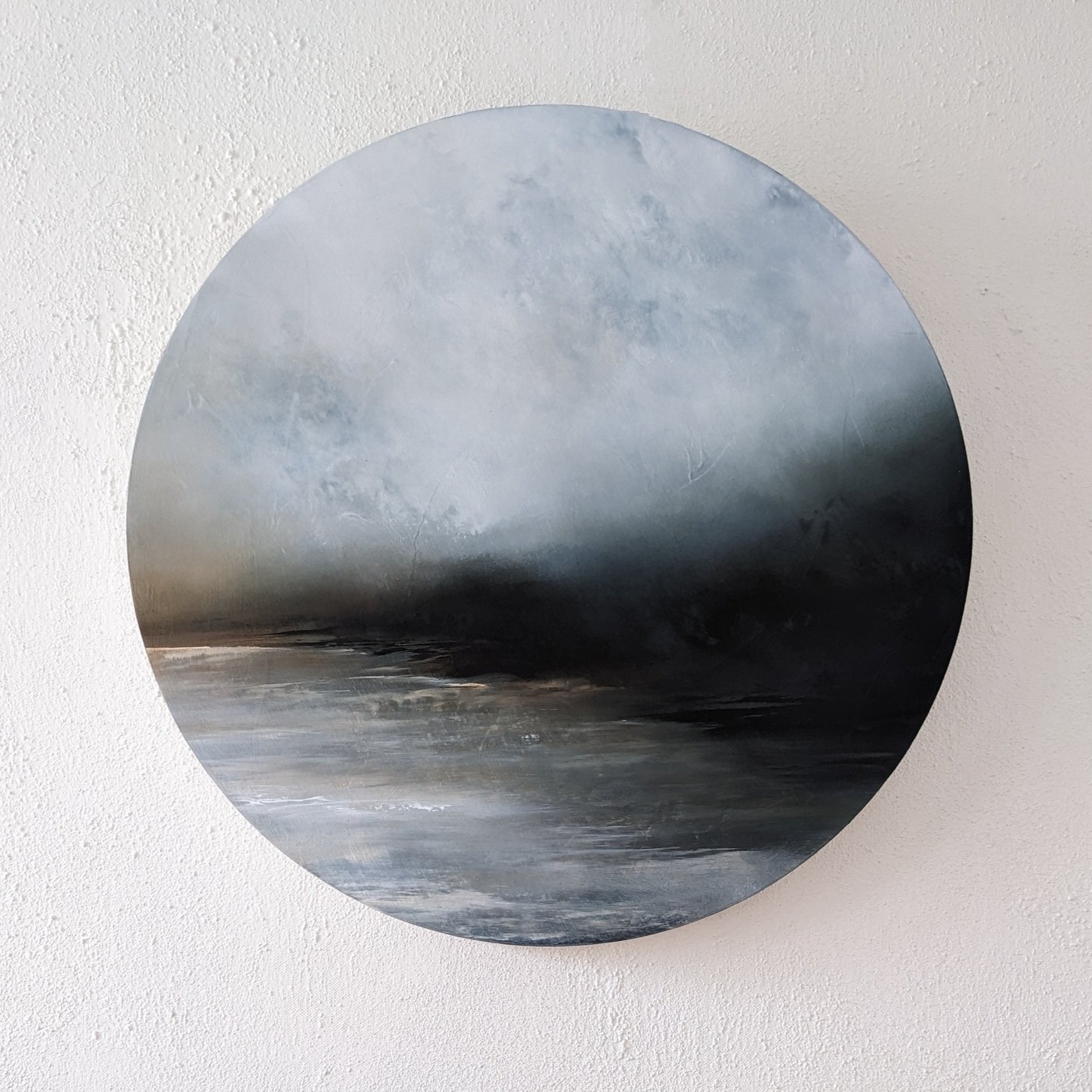 An original oil painting titled "On the Edge of Shadows" by artist Tori Tipton of abstract landscape in atmospheric muted shades hung on a wall