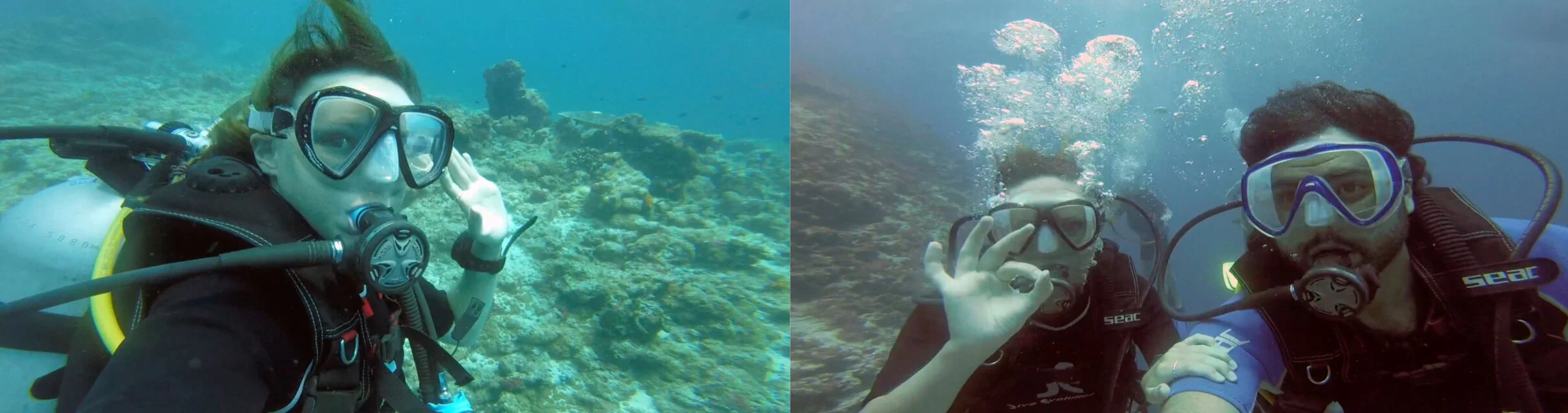 Two scuba divers underwater taking a selfie, making the 'OK' hand gesture, with a coral reef in the background.