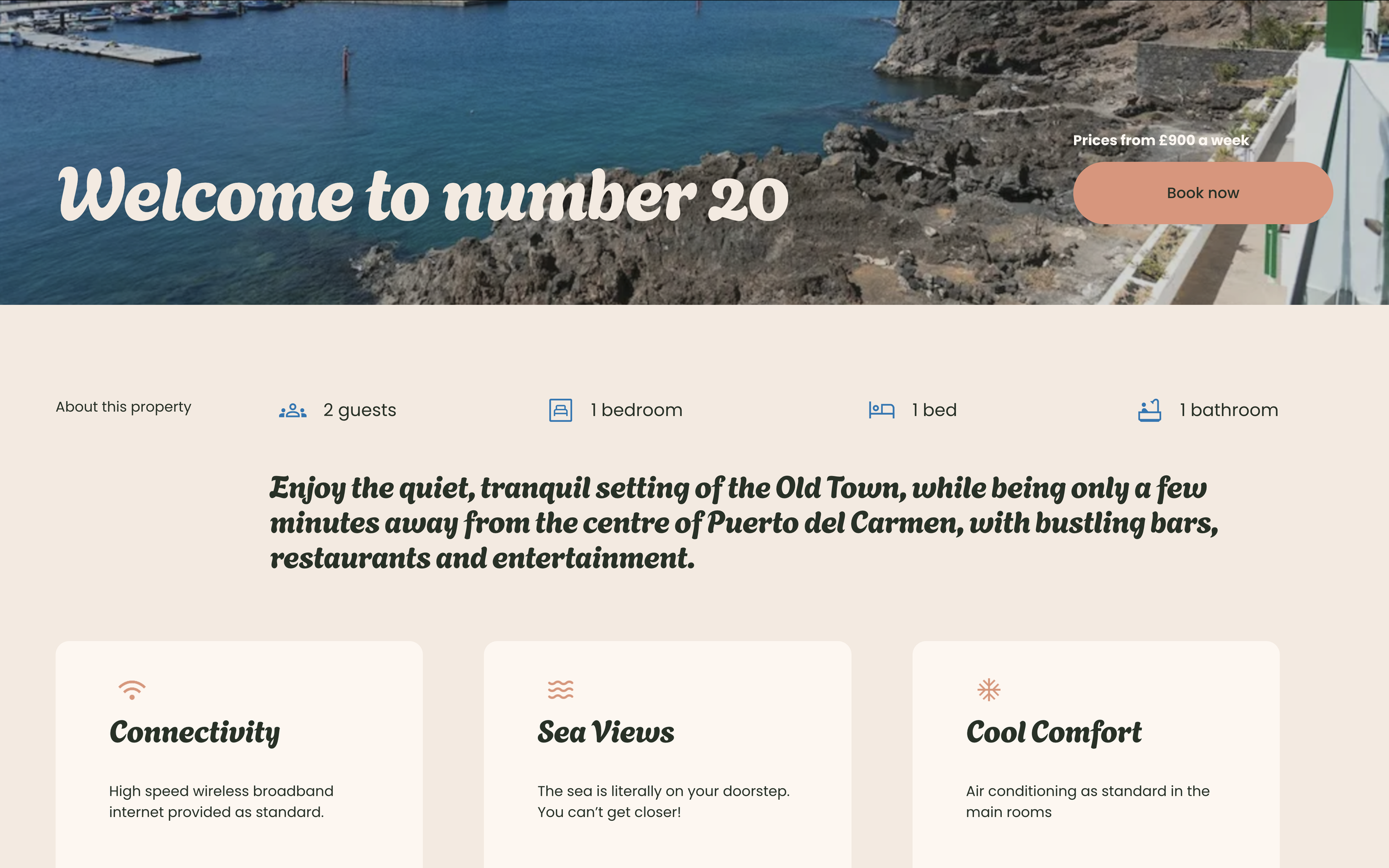 A webpage featuring a coastal property with a background image of rocky shoreline and blue waters. The page headline reads 'Welcome to number 20,' with a booking button and property details including 2 guests, 1 bedroom, 1 bed, and 1 bathroom. There 