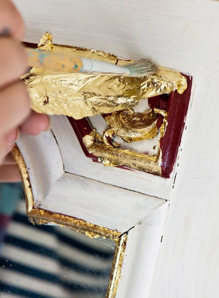 Brass-Loose-Leaf-being-applied-to-a-mirror-painted-with-Chalk-Paint-in-Bugundy-and-Old-White-Credit-CICO-BOOKS-Christopher-Drake-1800.jpeg