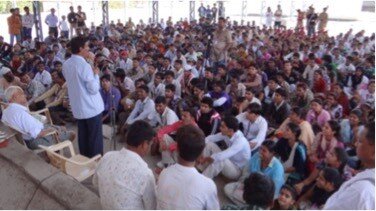 Popatrao Baguji Pawar addresses a meeting with residents of Hiware.jpg