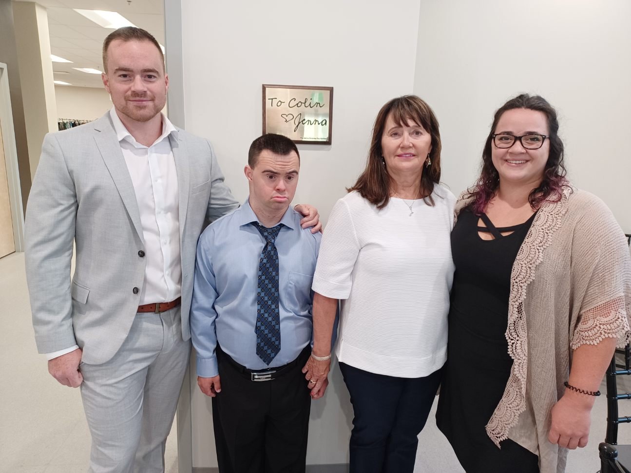  Delaney family being photographed with plaques which can be found in several locations in the building in memory of Jenna Delaney. 