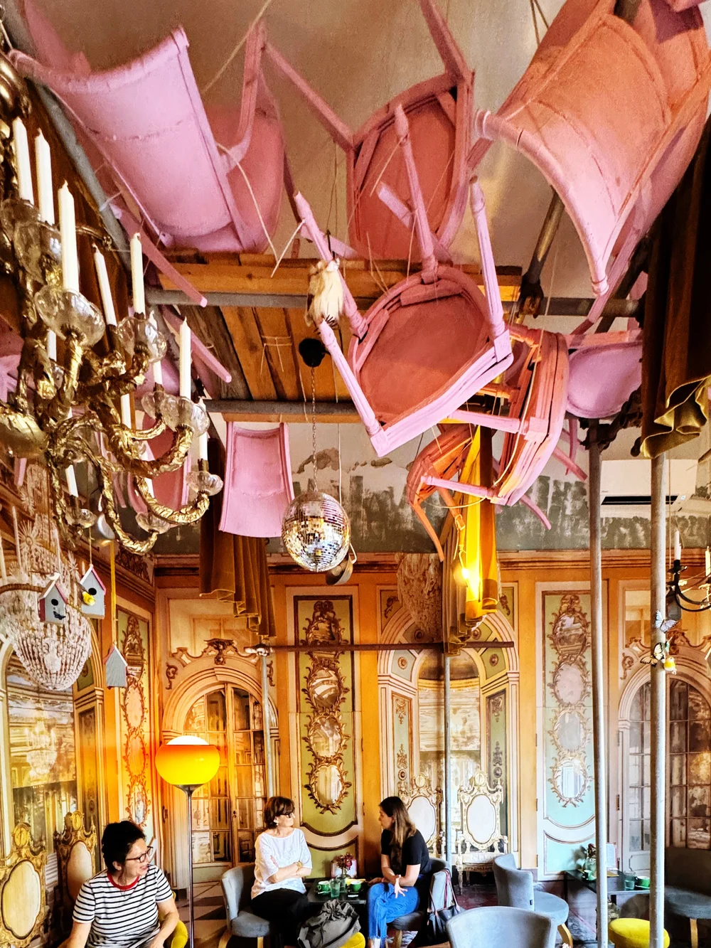  Pink chairs suspended from the ceiling in Program Bar.  