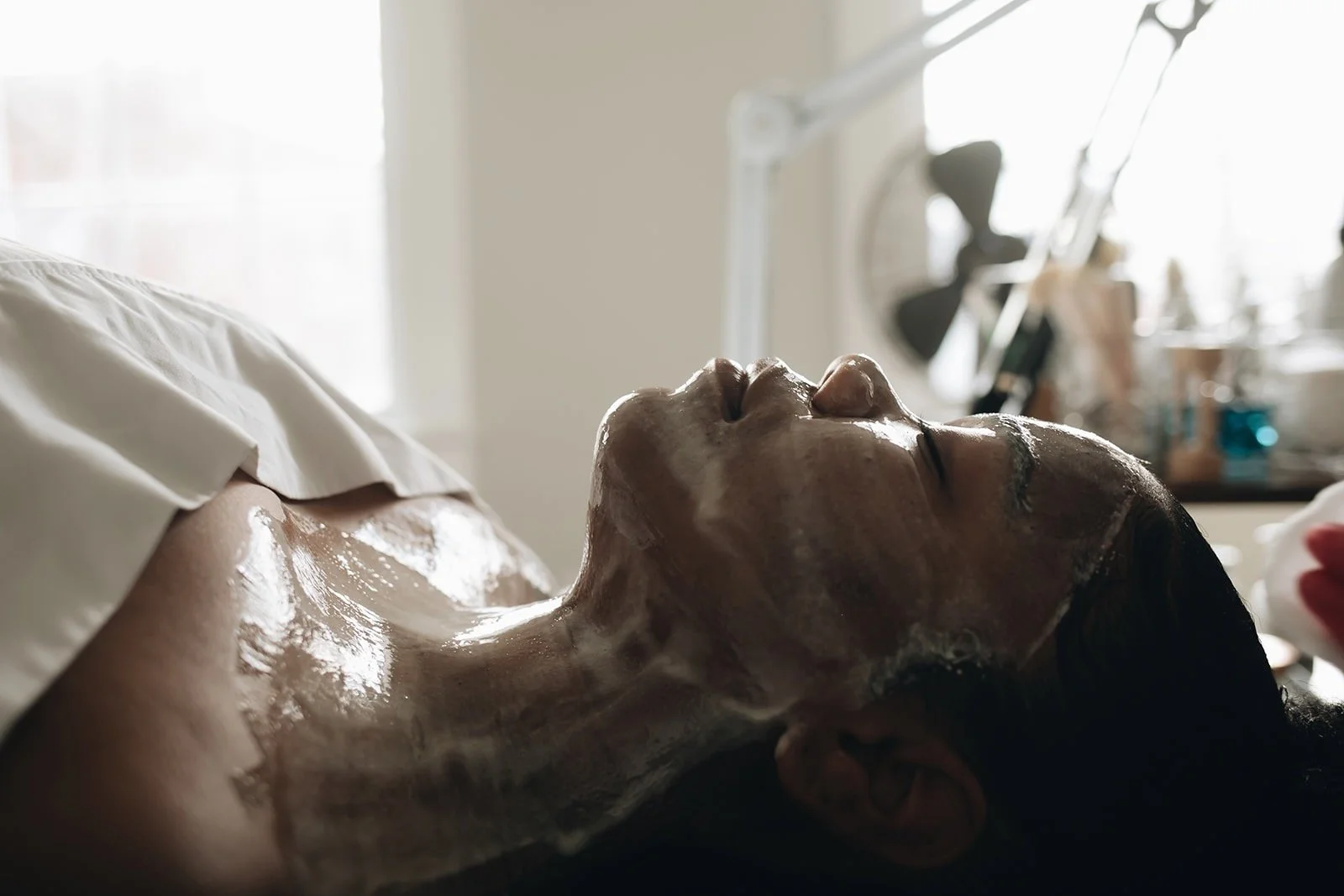 DMK enzyme mask covering the face, neck, and upper chest during treatment at Bespoke Aesthetics
