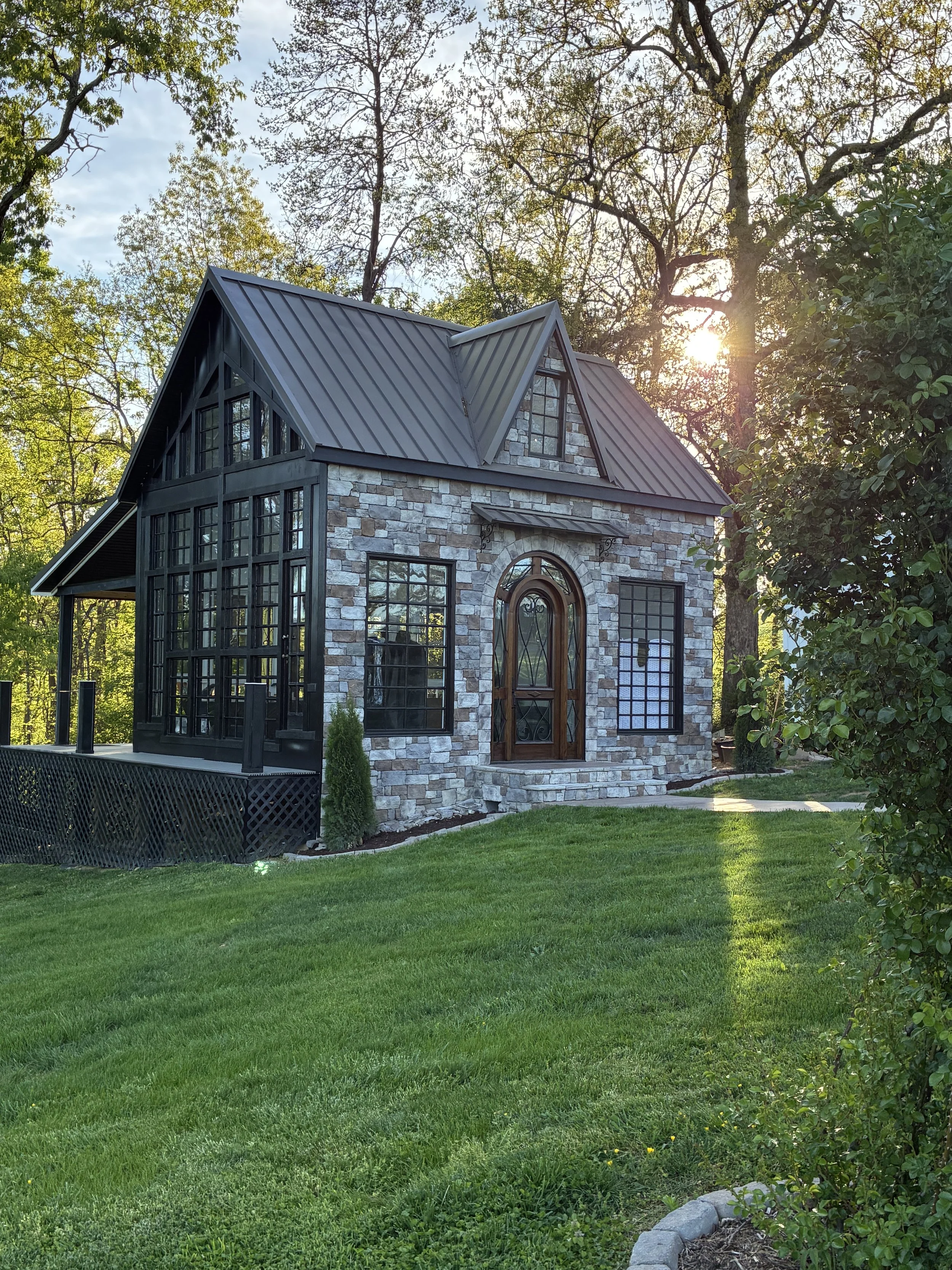 The glass cottage at Greenwood Oaks seen at sunset.