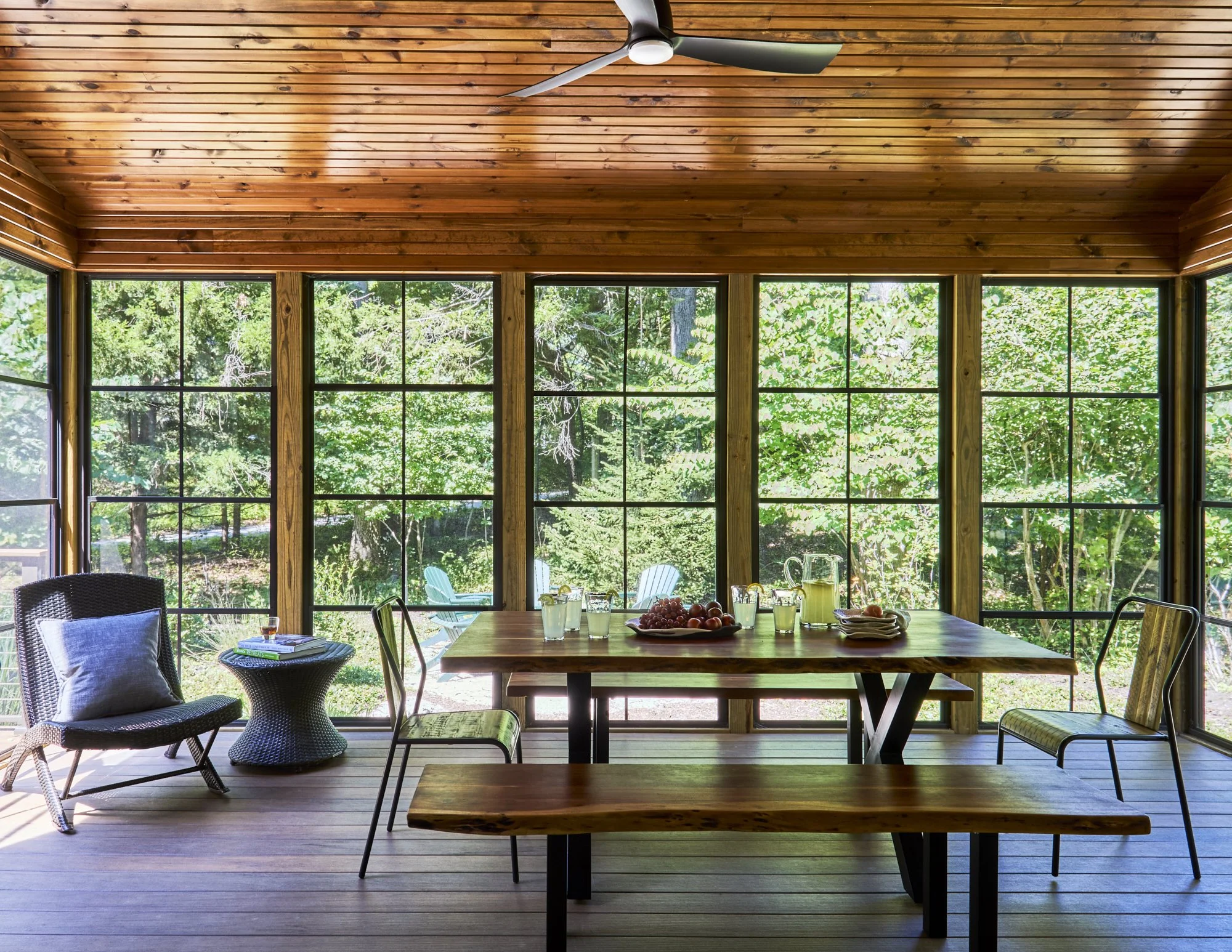 Screened porch with black steel framing overlooking wooded lot, Long Beach Indiana beach house