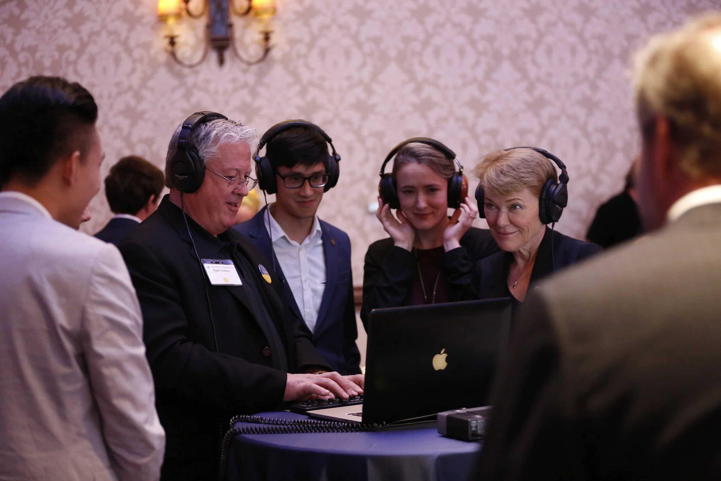  President Sarah Mangelsdorf and her family join Mark Watters, director of the Beal Institute for Film Music and Contemporary Media, to listen to student compositions for film and video projects. 