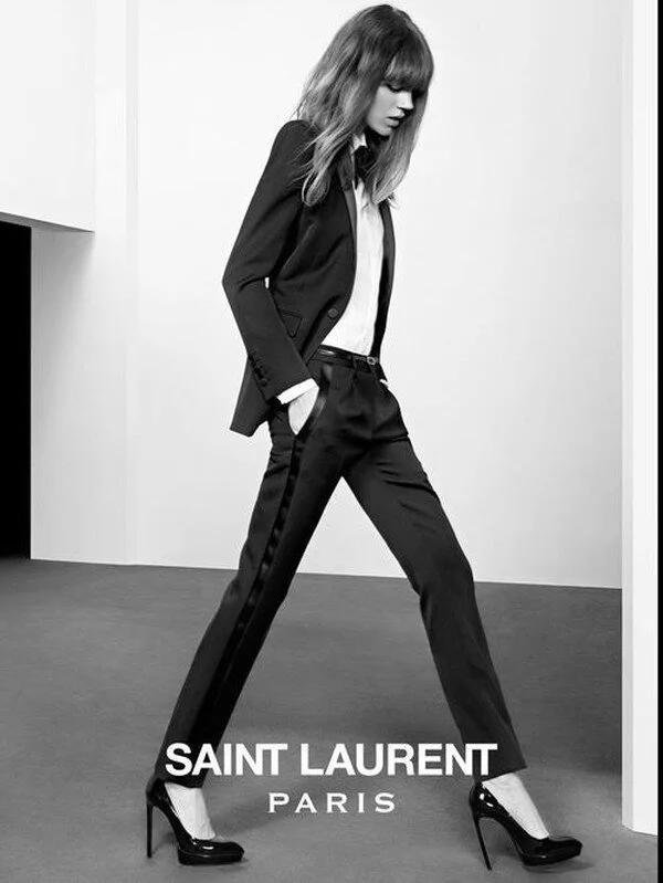 A Saint Laurent ad campaign showing the modern ‘Le Smoking’ paired with sky-high heels.