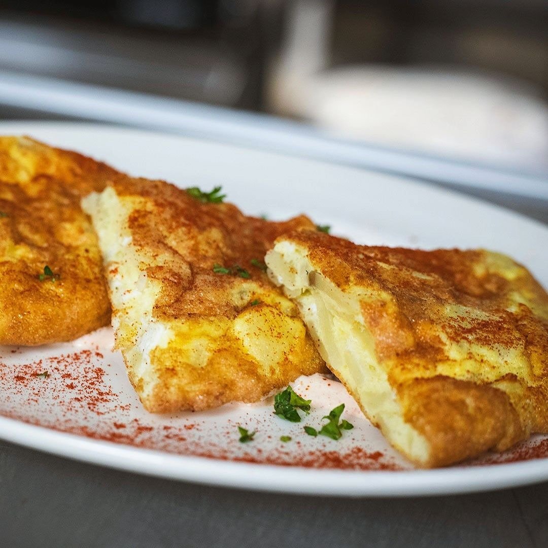 Our tortilla espa&ntilde;ola is a potato, onion, and egg omelet cooked to order and served with pimenton crema. If you&rsquo;re looking for traditional tapas to try on your next visit, this is a great place to start!