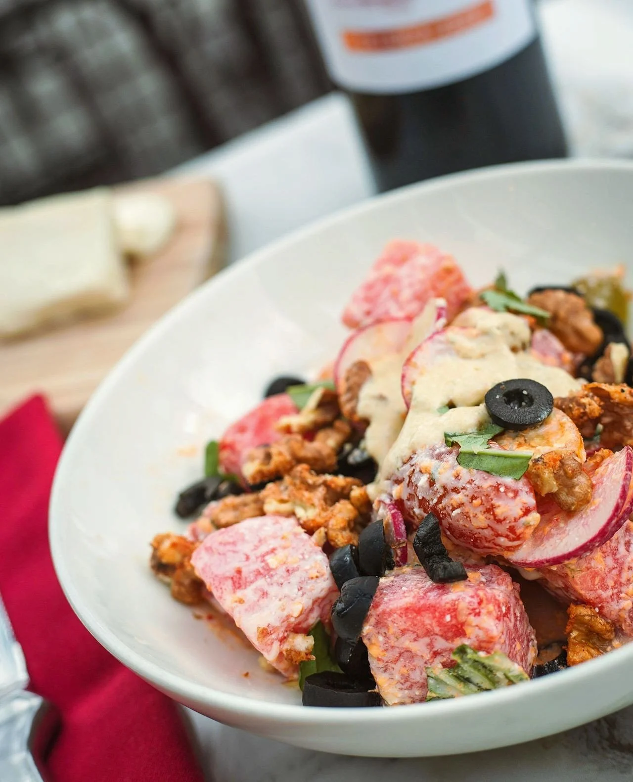 Fresh watermelon, heirloom cherry tomatoes, basil, black olives, spicy feta dressing, and candied walnuts come together in a seasonal salad that's bright, refreshing, and full of flavor.⁠
⁠
Now available as a chef special in Worcester and Wellesley. 