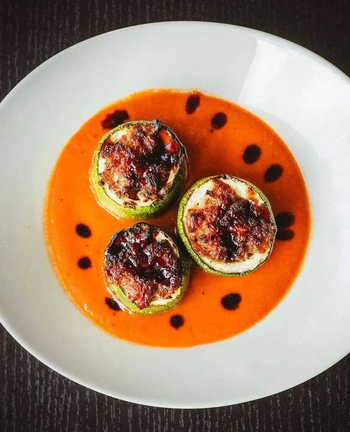 Stuffed Zucchini filled with Portuguese lingui&ccedil;a and fontina, finished with roasted red pepper sauce and port wine molasses. It's a seasonal favorite that's only around for a short time.⁠
⁠
Reserve your table and catch it while you can.