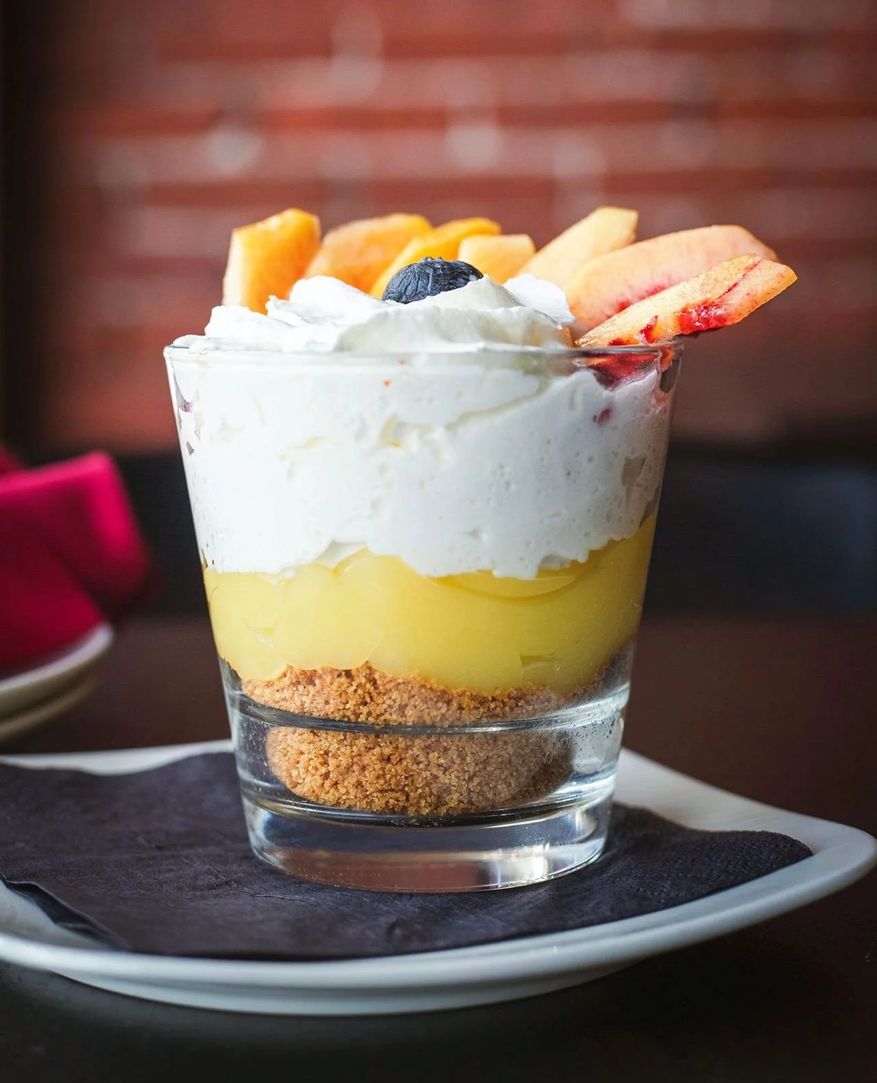 A little tart, a little sweet, and made for the final course. 🍋🍑⁠
⁠
Our Lemon &amp; Peach Parfait layers graham cracker, lemon curd, whipped cream, diced peaches, and peach syrup into one seriously summery dessert.⁠
⁠
Available now as one of Chef&r