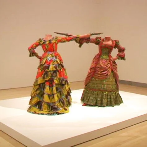 Yinka Shonibare artwork of headless individuals in dresses pointing guns at each other