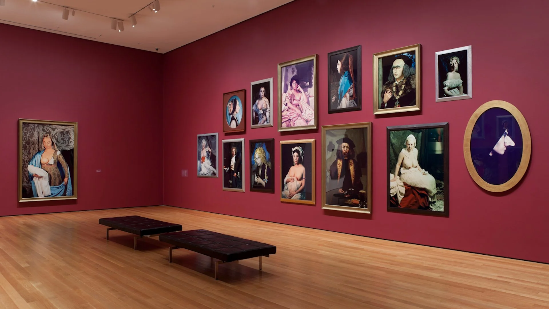 Cindy Sherman artwork on a red wall in a gallery