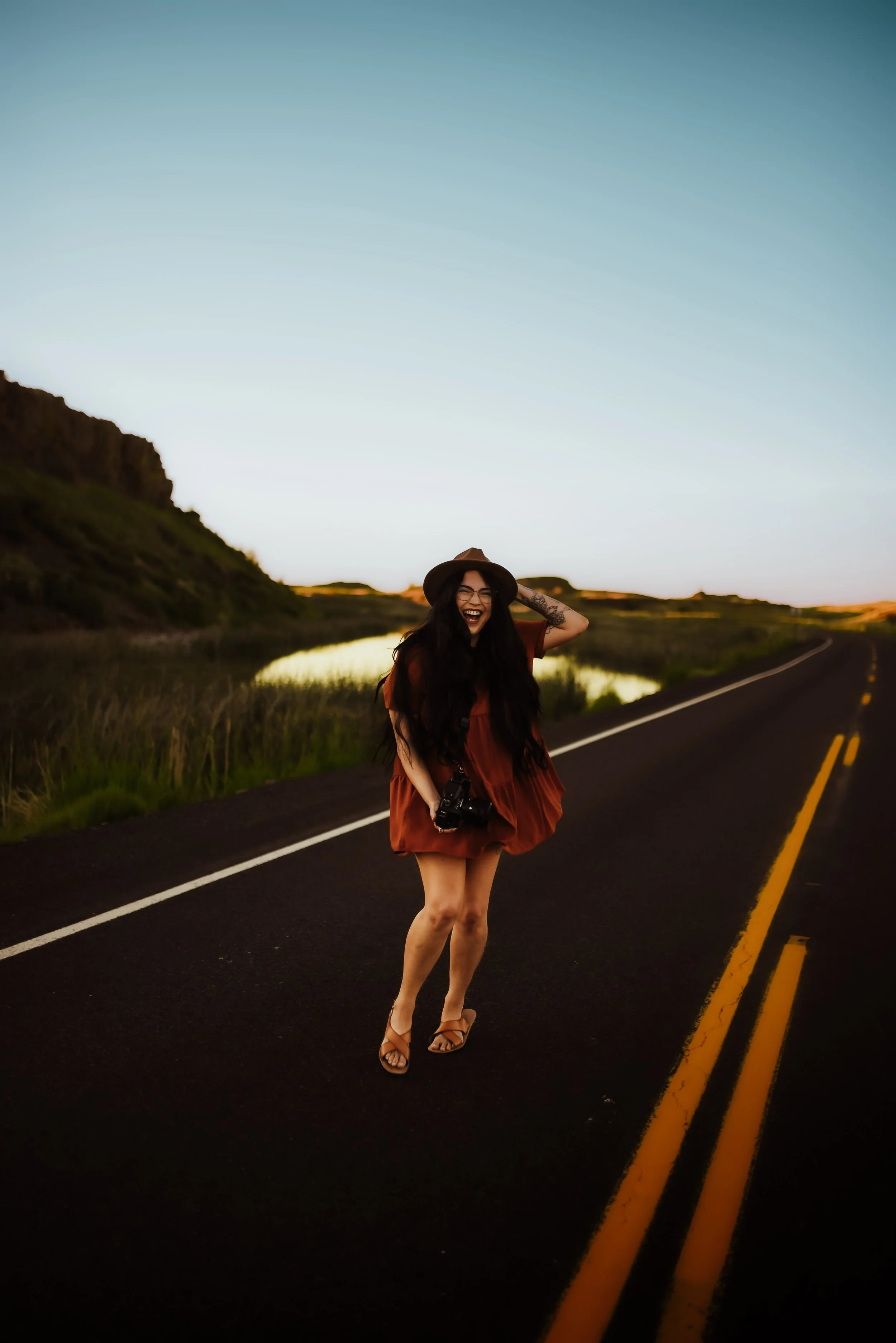 Angel with camera in hand, shooting an elopement session in the PNW