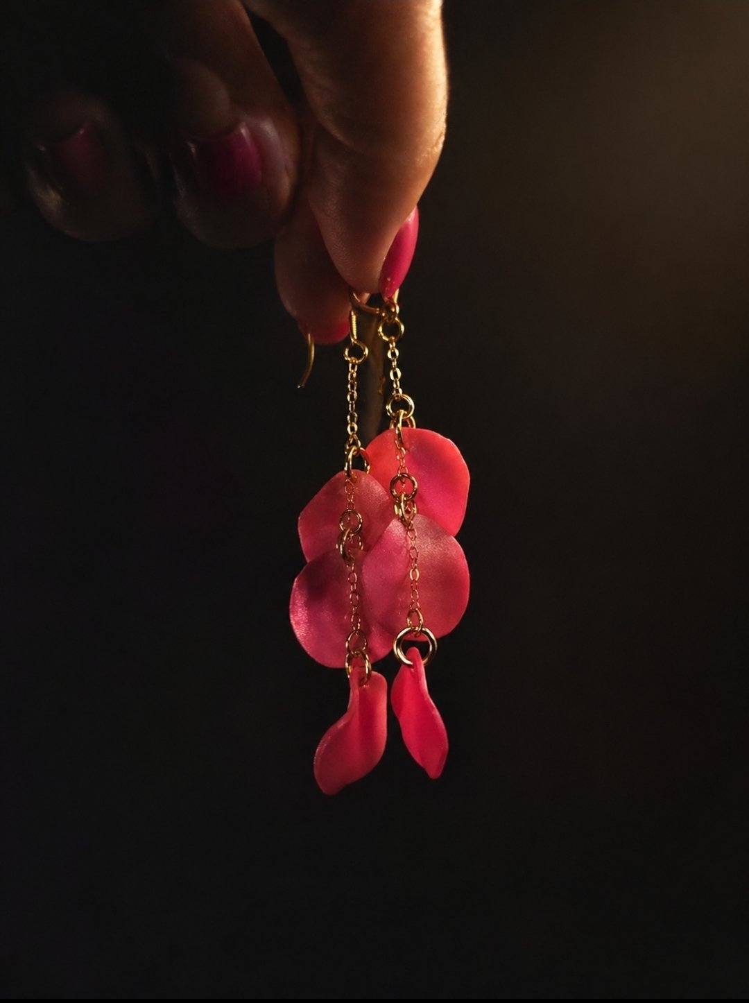 Handmade pink petal bloom clay earrings with delicate layered detail, gold-filled hook, side angle view