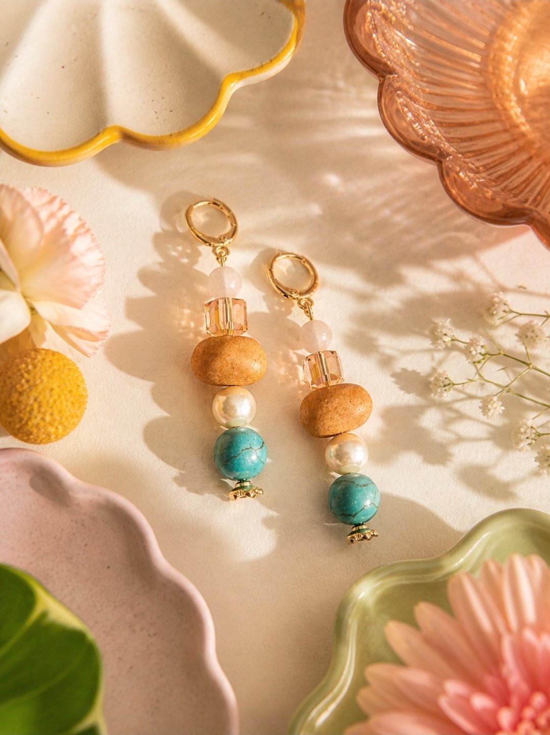 Hand beaded champagne crystal, turquoise stone, and pearl drop earrings on gold-plated huggie, by Akay Collective