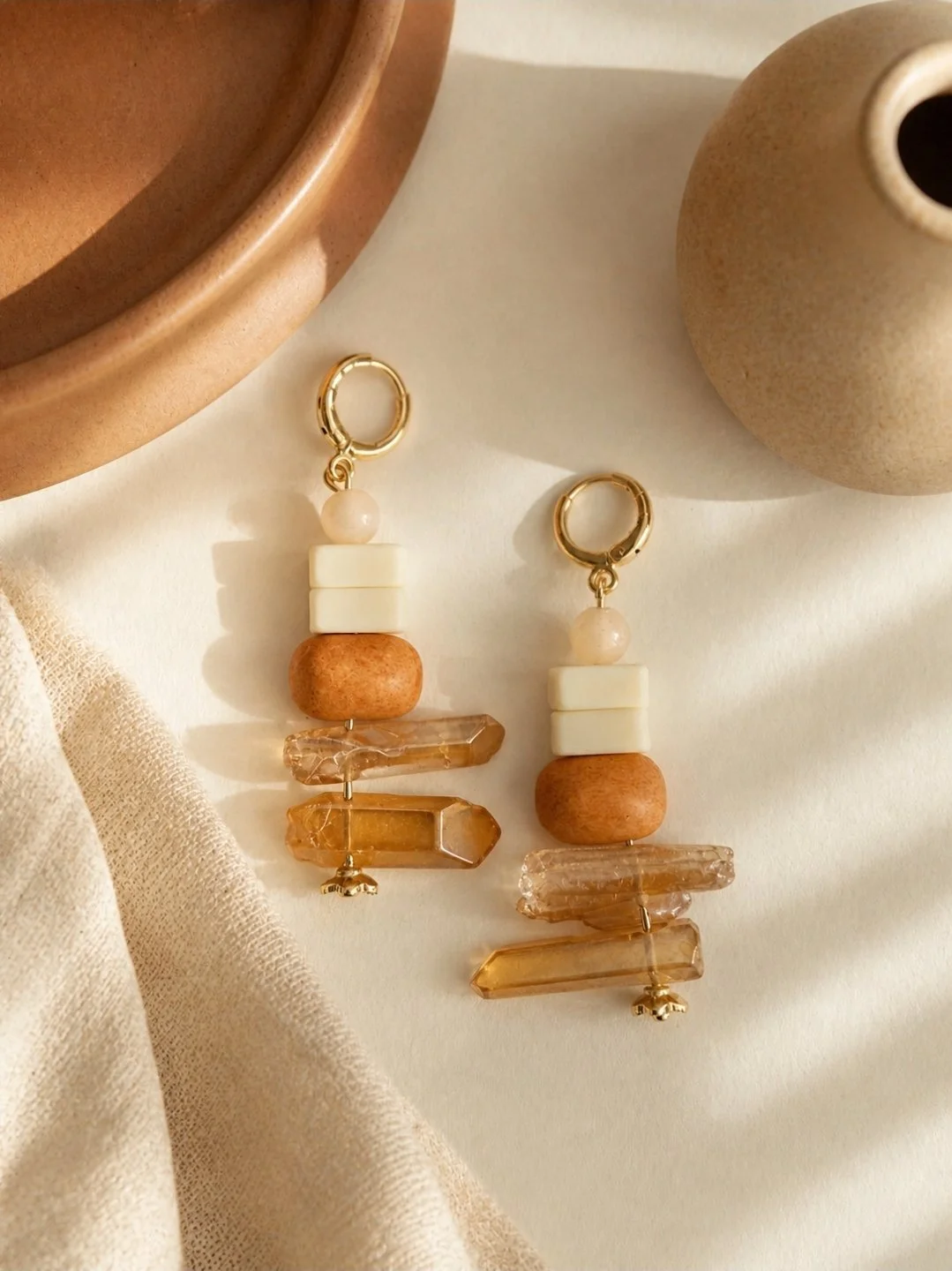 Hand beaded neutral drop earrings with cream square beads and chunky terracotta round bead on gold-plated huggie, by Akay Collective