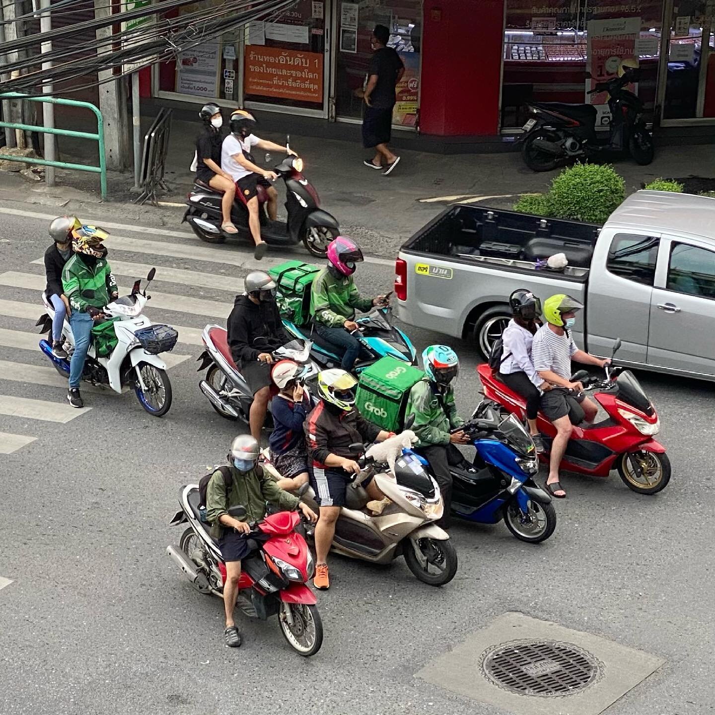 An unusual sight in Bangkok. No... not the dog on the handlebars... but rather, what is unusual is the fact that ever motorcycle rider in this photo, is actually wearing a helmet. #bangkok #dog #thailand