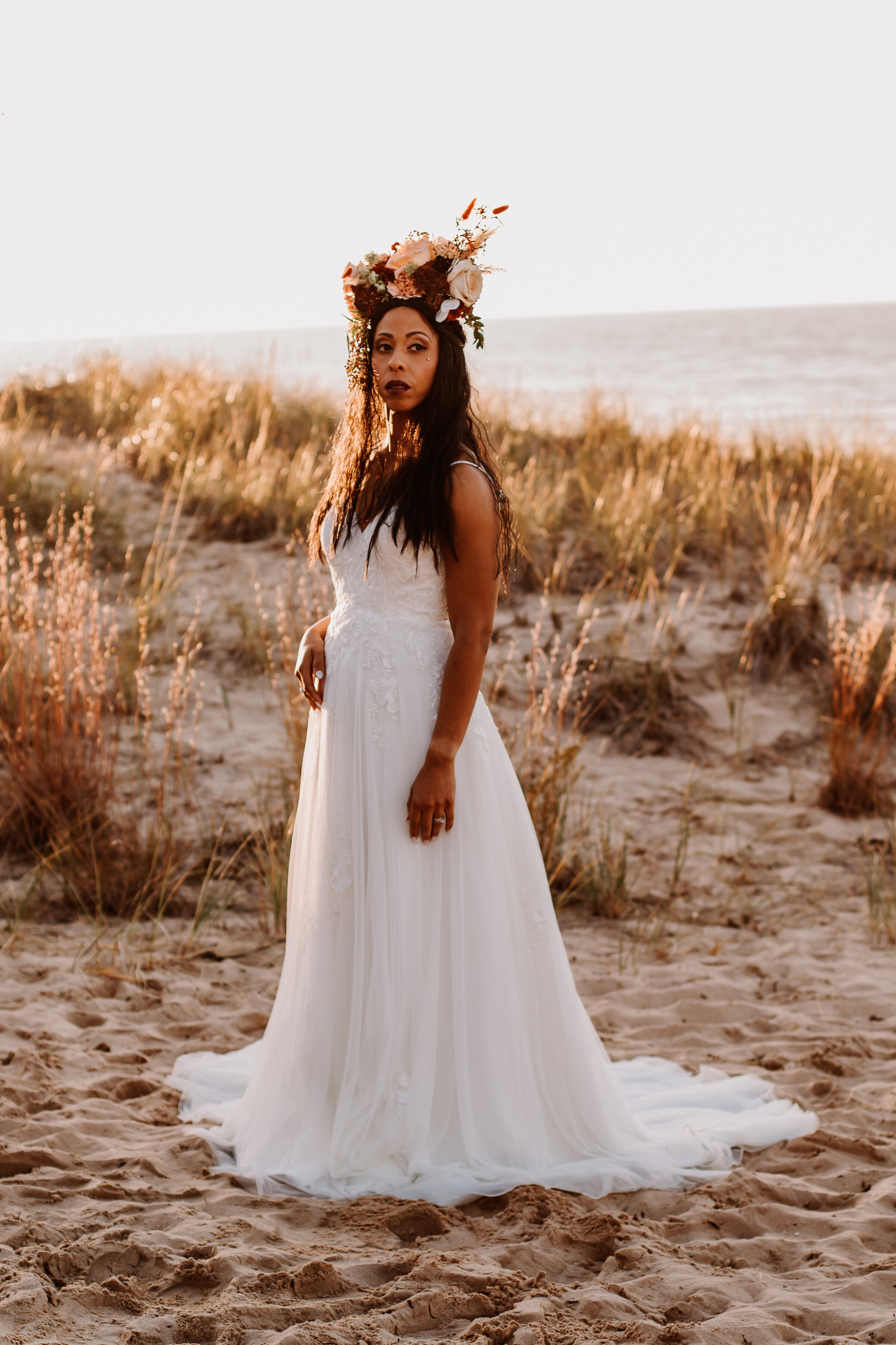  A stunning bohemian bride wearing an elaborate floral headpiece at an elopement styled shoot near Chesterton, Indiana. lake michigan bridal ensemble inspo boho bride floral crown bohemian flower crown adventurous beach wedding inspiration for midwes