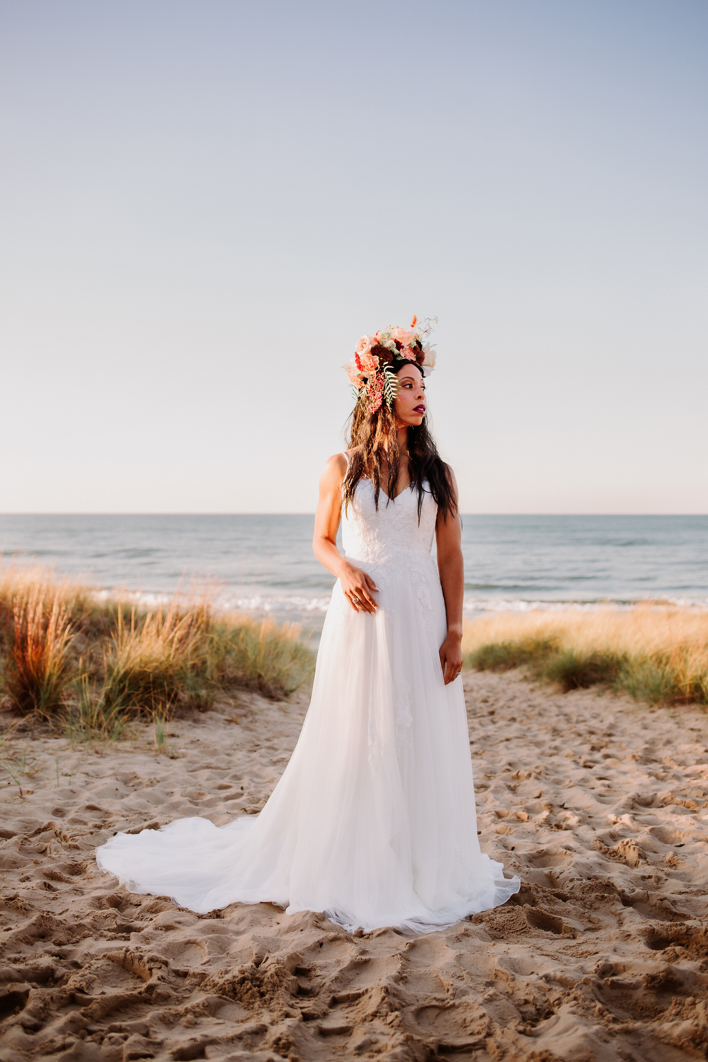  Boho bride wearing a floral headdress styled for an elopement shoot on the shores of Lake Michigan in Indiana Dunes State Park.&nbsp; Valparaiso Indiana photography Chesterton photographer Lake Michigan elopement beach wedding flowy wedding dress bo