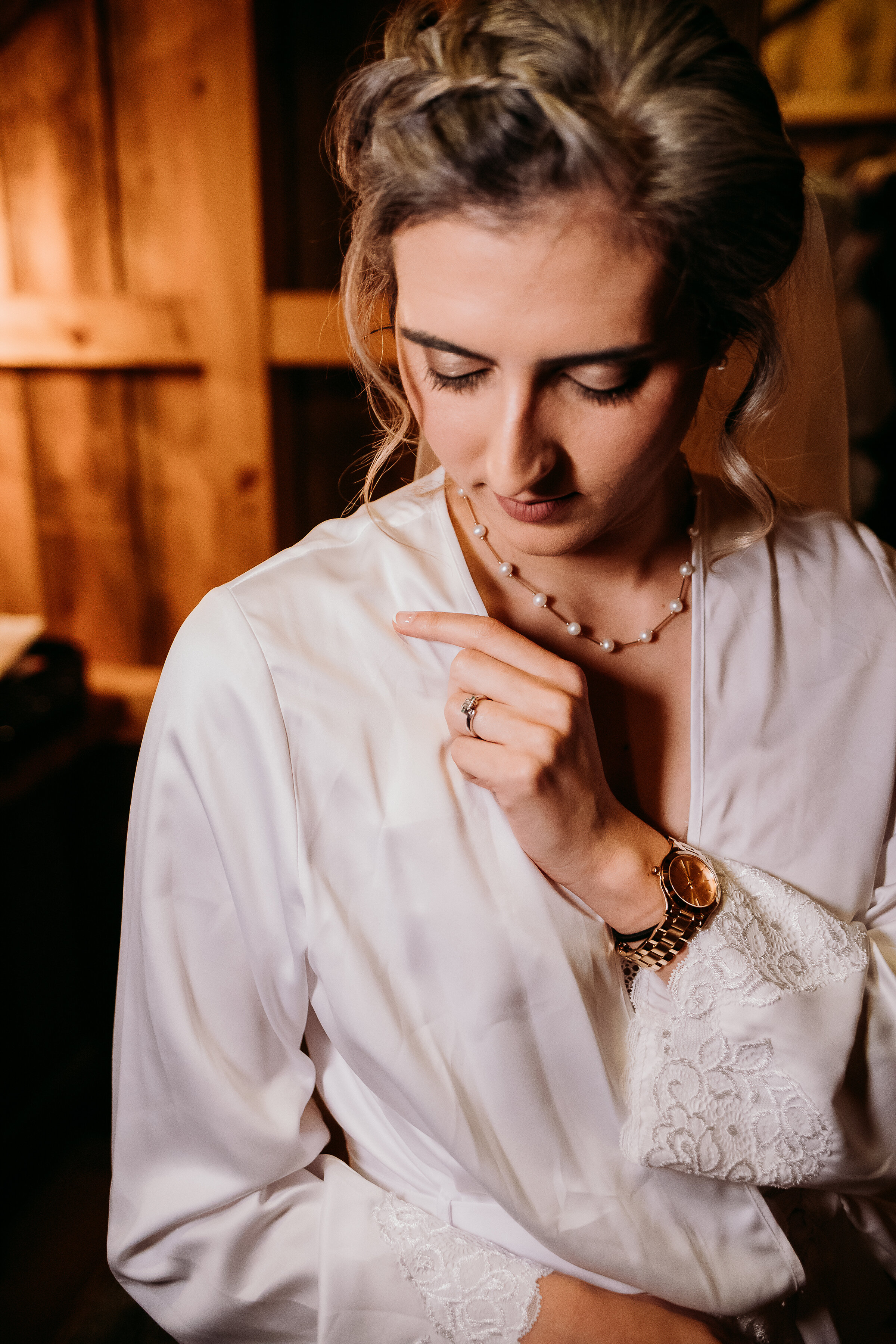  Kindred + Co, Photography uses moody natural lighting to capture wedding morning getting ready shots of soon-to-be-bride in Northeastern, Ohio. pearl minimalist wedding necklace, treehouse wedding, elopment, treehouse elopment, professional northeas