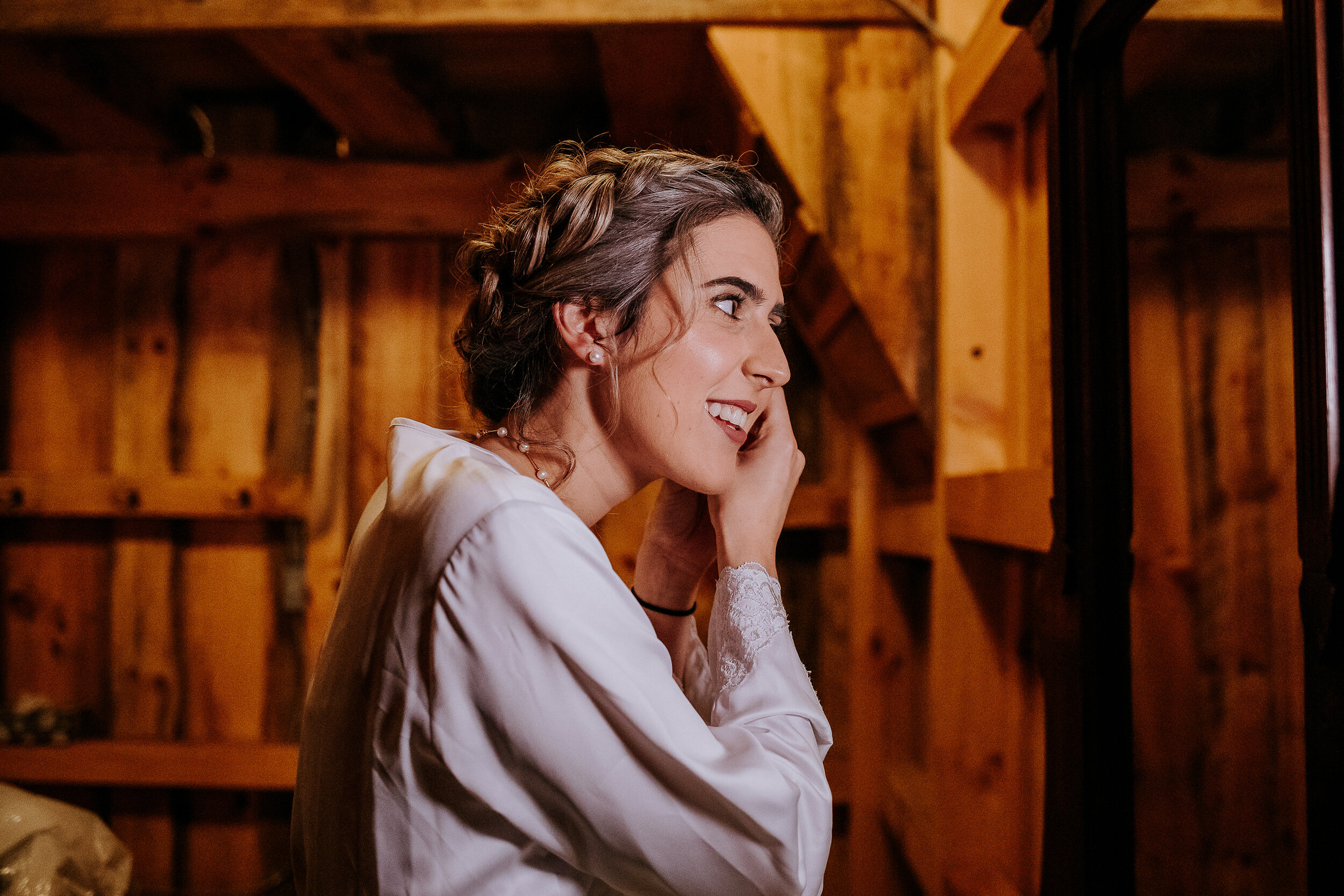  Candidly happy moments of a beautiful bohemian styled bride on her wedding morning captured by Kindred + Co. Photography in Akron, Ohio. bohemian bride, bohemian braided wedding updo, wedding day makeup, silk wedding morning robe, pearl wedding neck