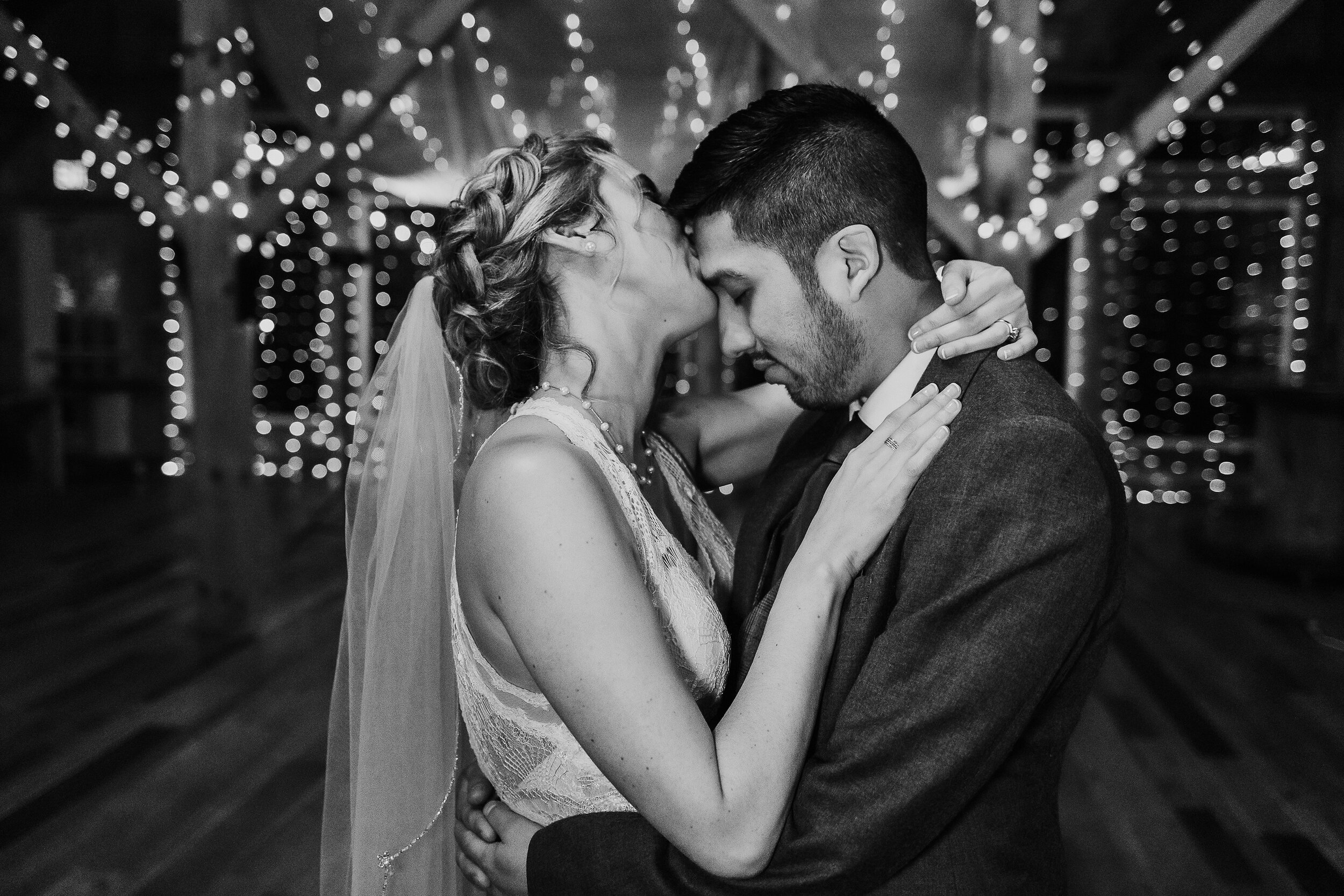  Kindred + Co. Photography captures sweet intimate moments following a romantic treehouse elopement in Akron, Ohio. slow dancing, string lights, organza ceiling wedding decor, bohemian lace wedding dress, boho wedding braid updo, forehead kissing, ar