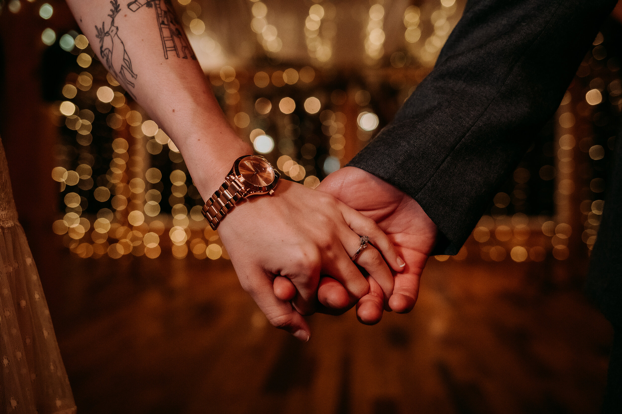  Kindred + Co. Photography captures wedding ring details at this intimate treehouse elopement in Akron, Ohio. rose gold wedding ring, rose gold wedding watch, deer tattoos, string lights, treehouse wedding, elopement, professional elopement photograp