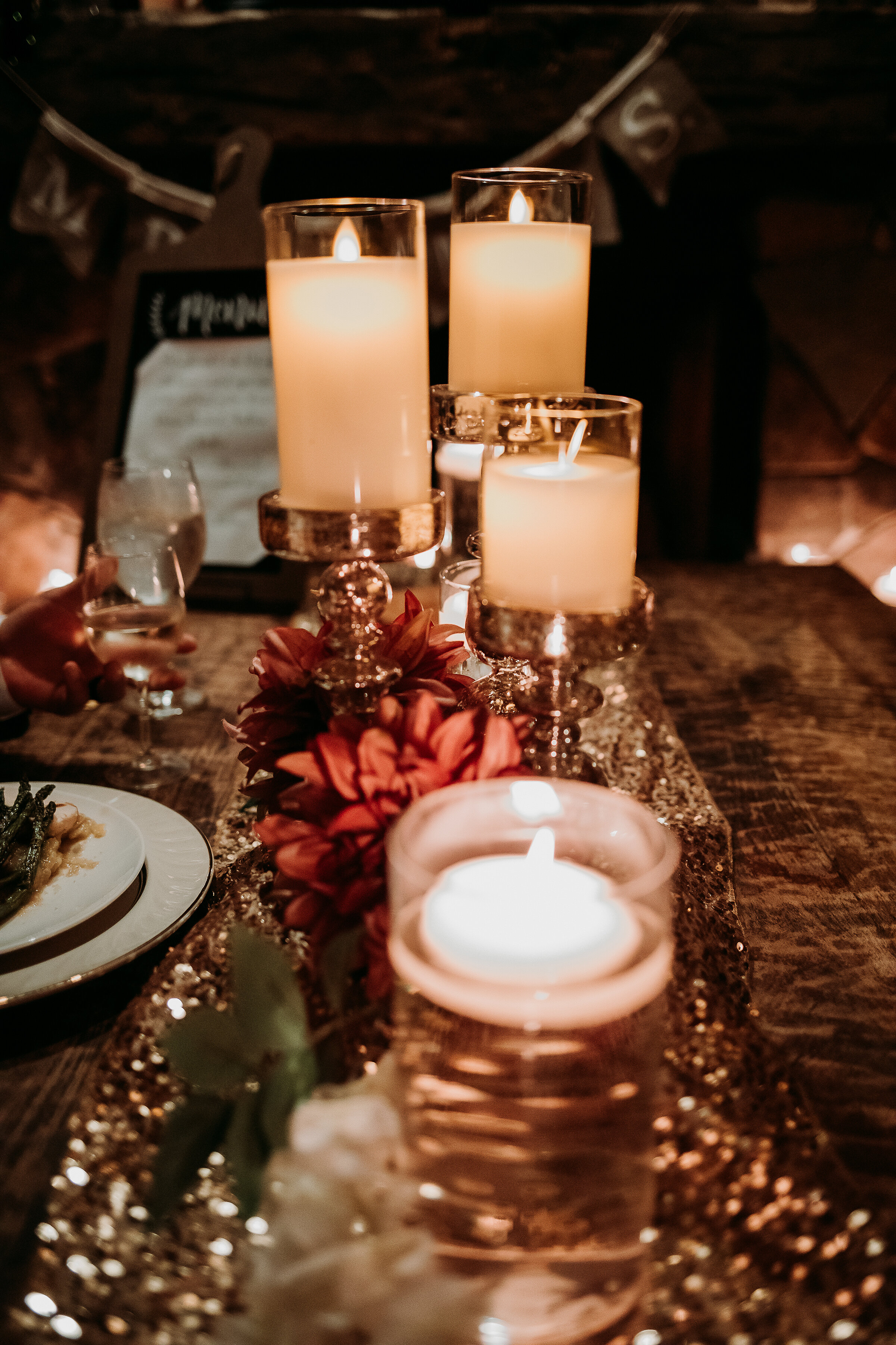  Elegant woodsy wedding table decor captured by Kindred + Co. Photography at this romantic candlelit treehouse elopement at the Grand Barn at the Mohicans. pinecone centerpiece, romantic candlelit dinner, white candles in vase, centerpiece candles, t