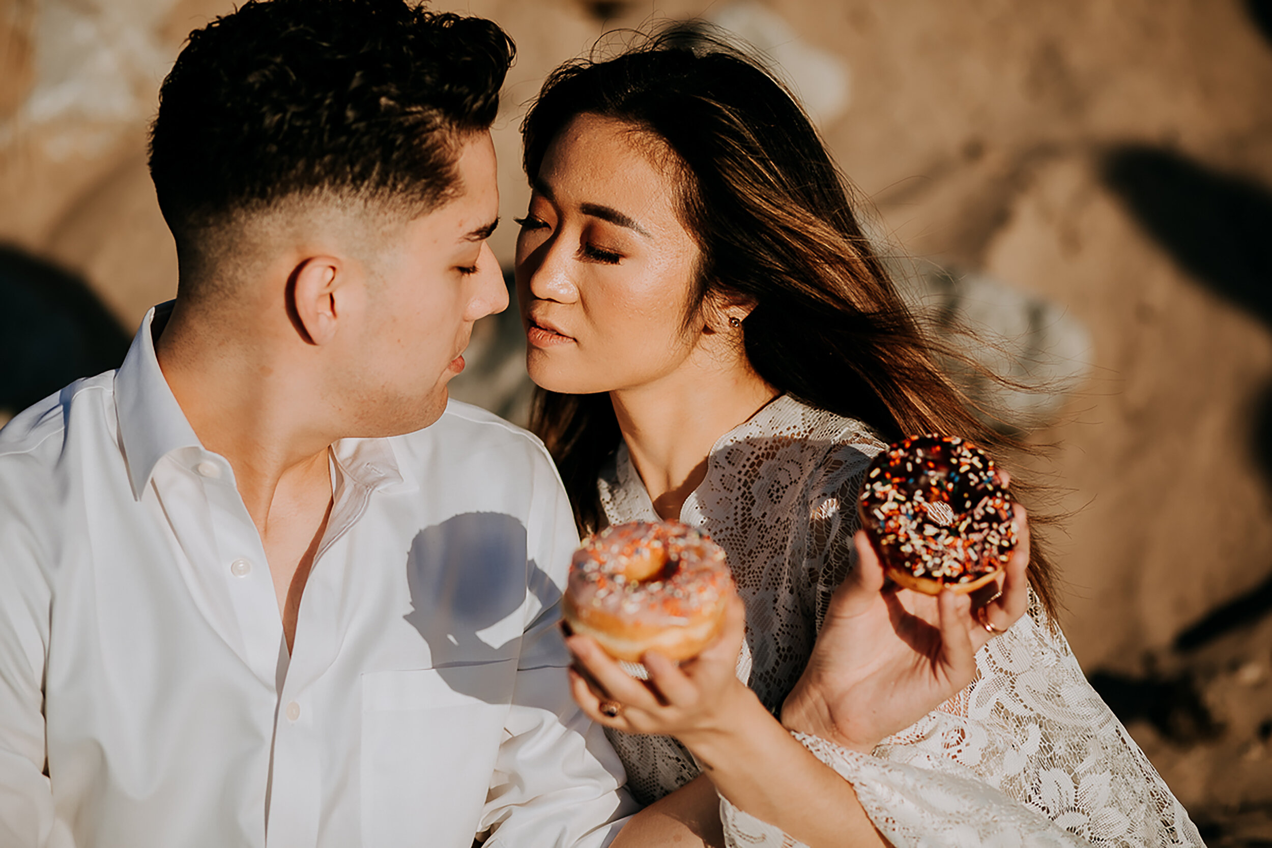  Newly eloped bride and groom celebrate wedding nuptials with sprinkled glazed donuts at Indiana Dunes State Park with Kindred &amp; Co. Photography. glazed sprinkled wedding donuts, lace bell sleeved wedding dress, casual bohemian elopement dress. w